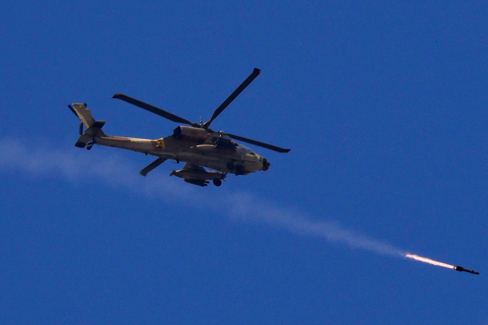 Israeli Apache attack helicopter fires a missile towards southern Lebanon, amid hostilities between Hezbollah and Israel