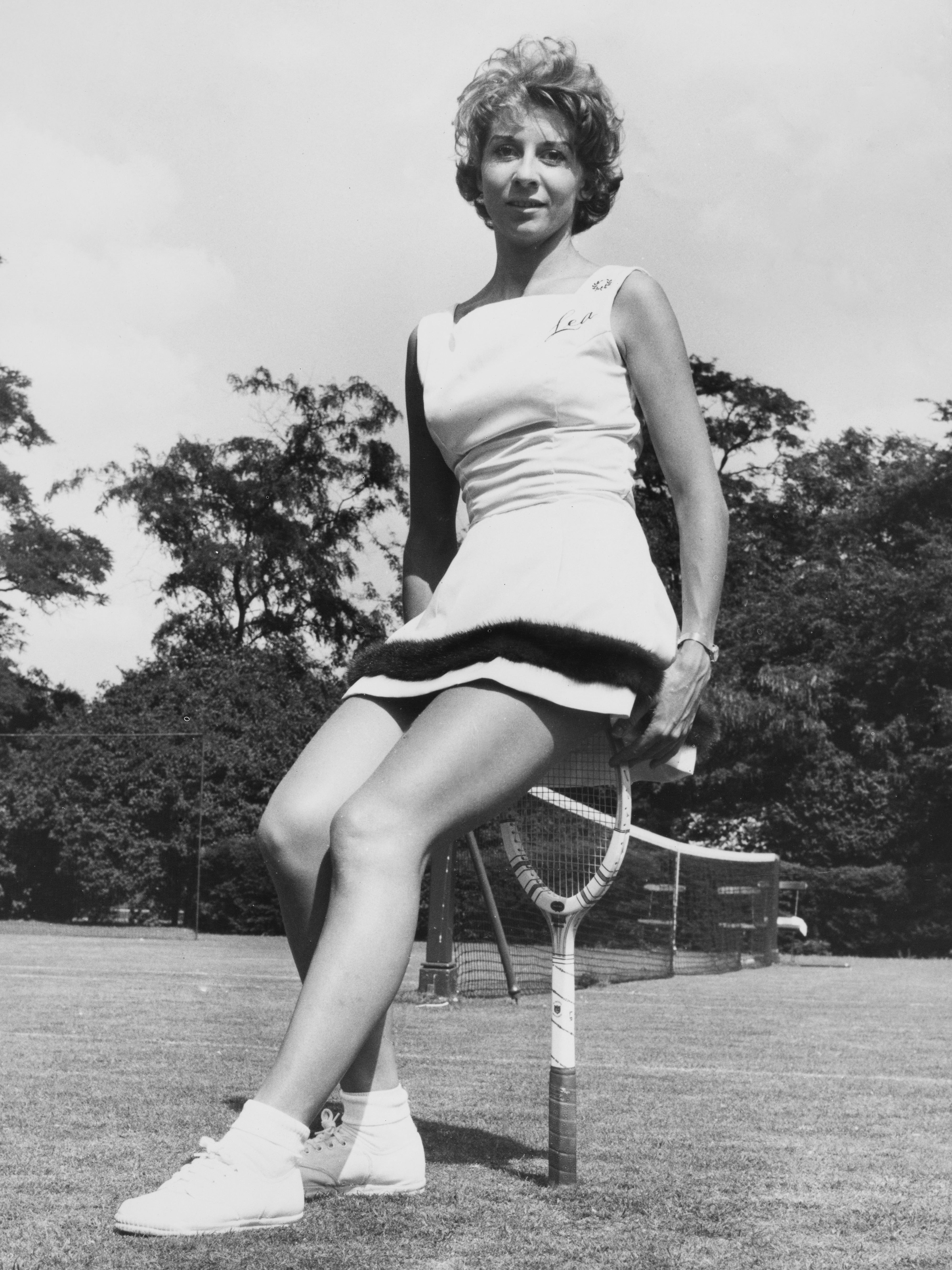 Tennis player Lea Pericoli of Italy poses wearing Trioel woven fabric outfit trimmed with Mink fur during the Hurlingham Tennis Tournament on 19 June 1960