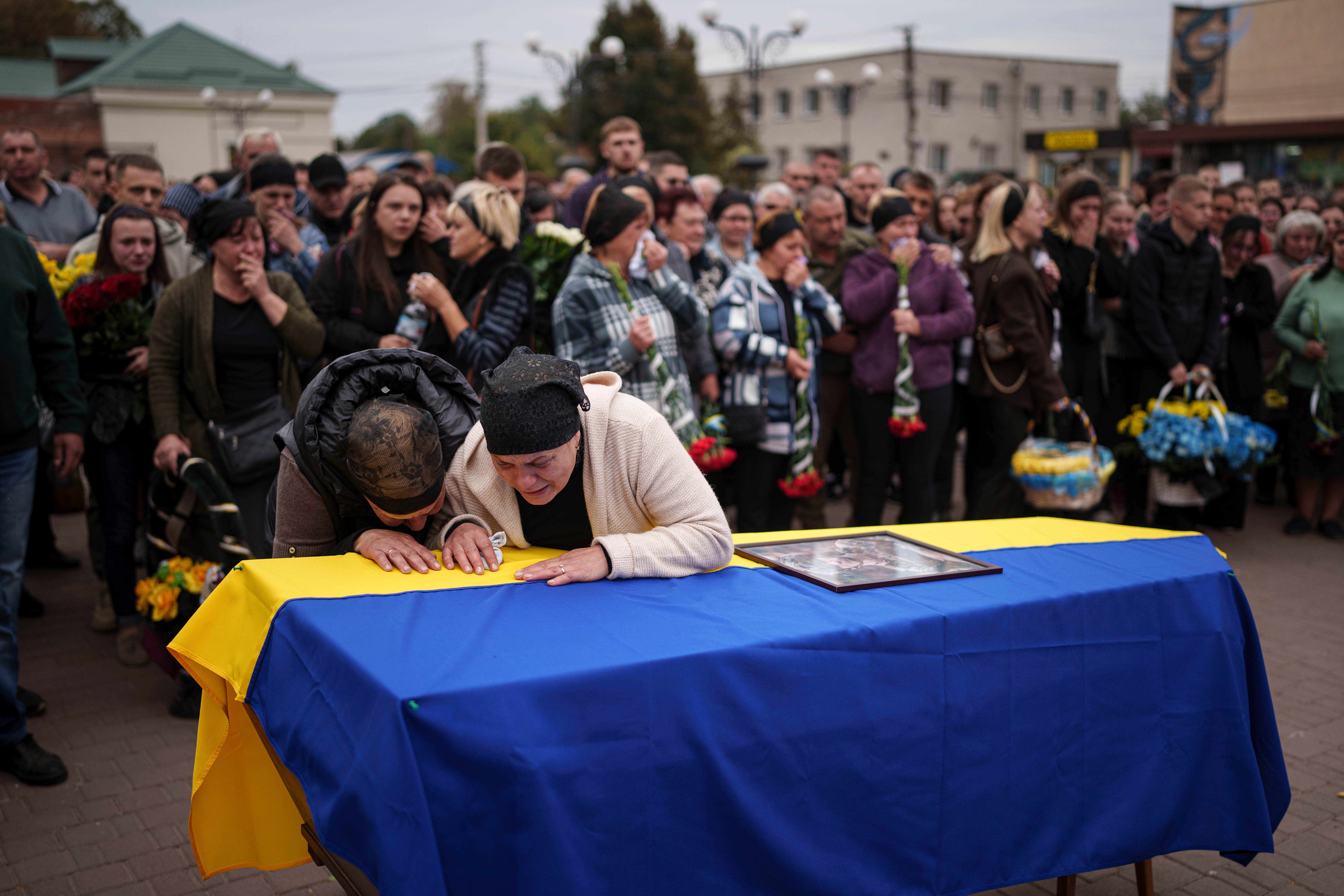 Mother Kateryna with her family cry over the coffin of her son Ihor Kusochek, Ukrainian soldier of the Azov brigade who was killed at the frontline in Toretsk, during the funeral ceremony in Bobrovytsia, Chernihiv region, Ukraine