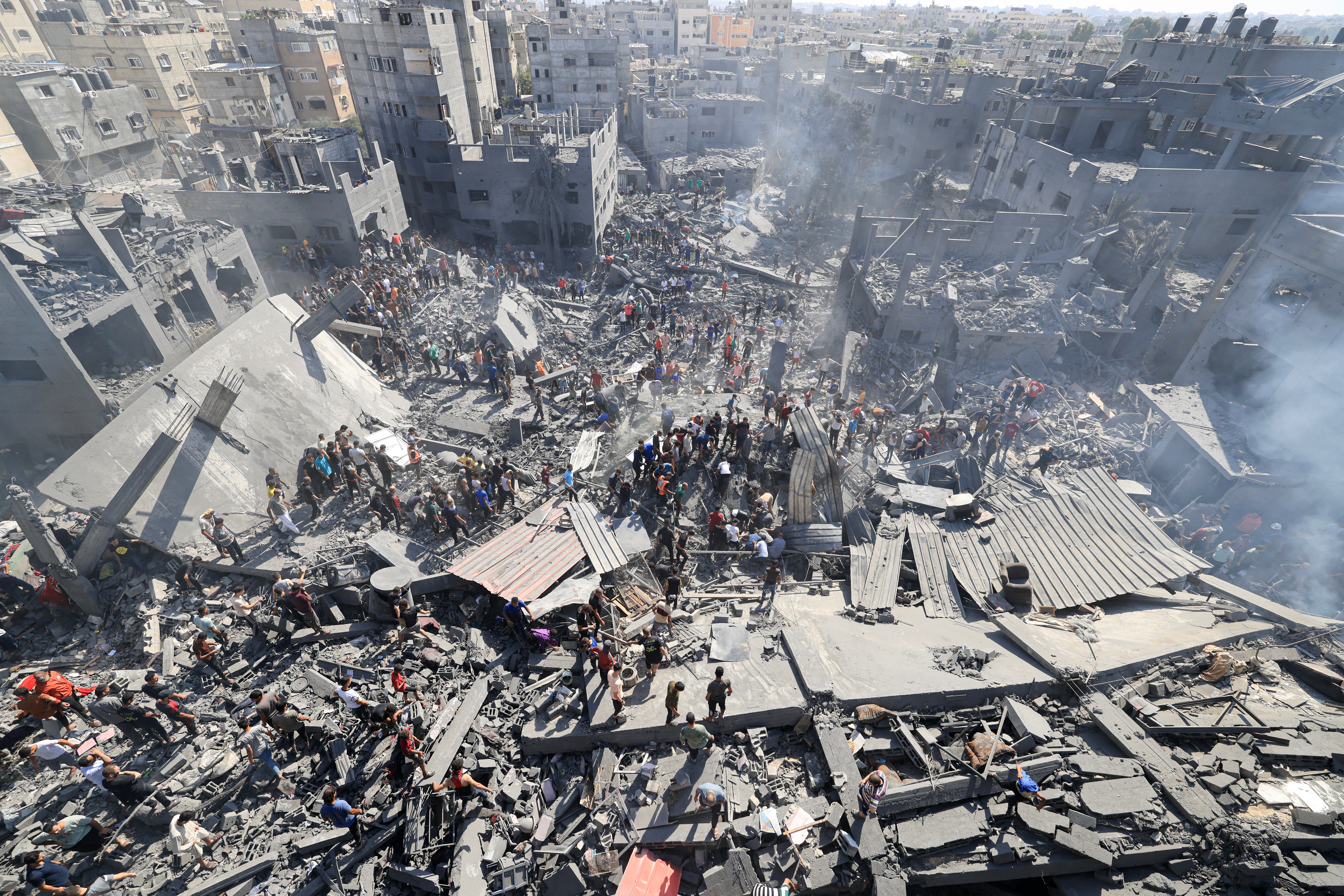 People search for survivors and the bodies of victims through the rubble of buildings destroyed during Israeli bombardment, in Khan Yunis in the southern Gaza last year