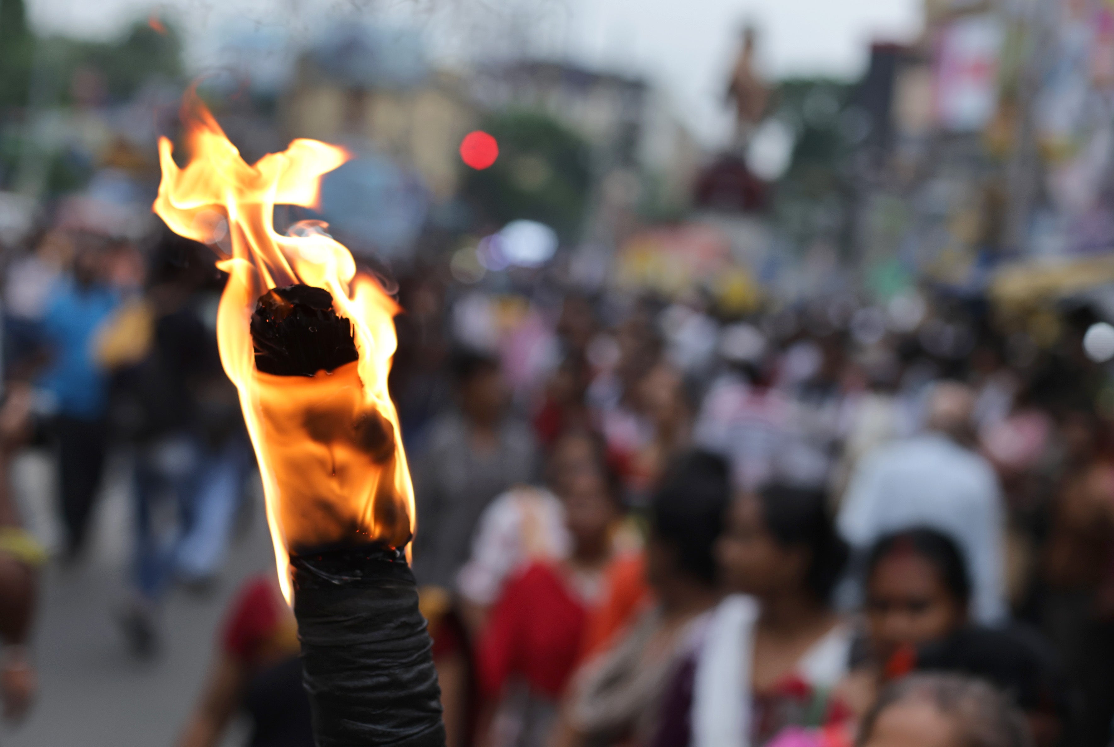 Protester holds torch as people march during protest against rape and murder at RG Kar medical college