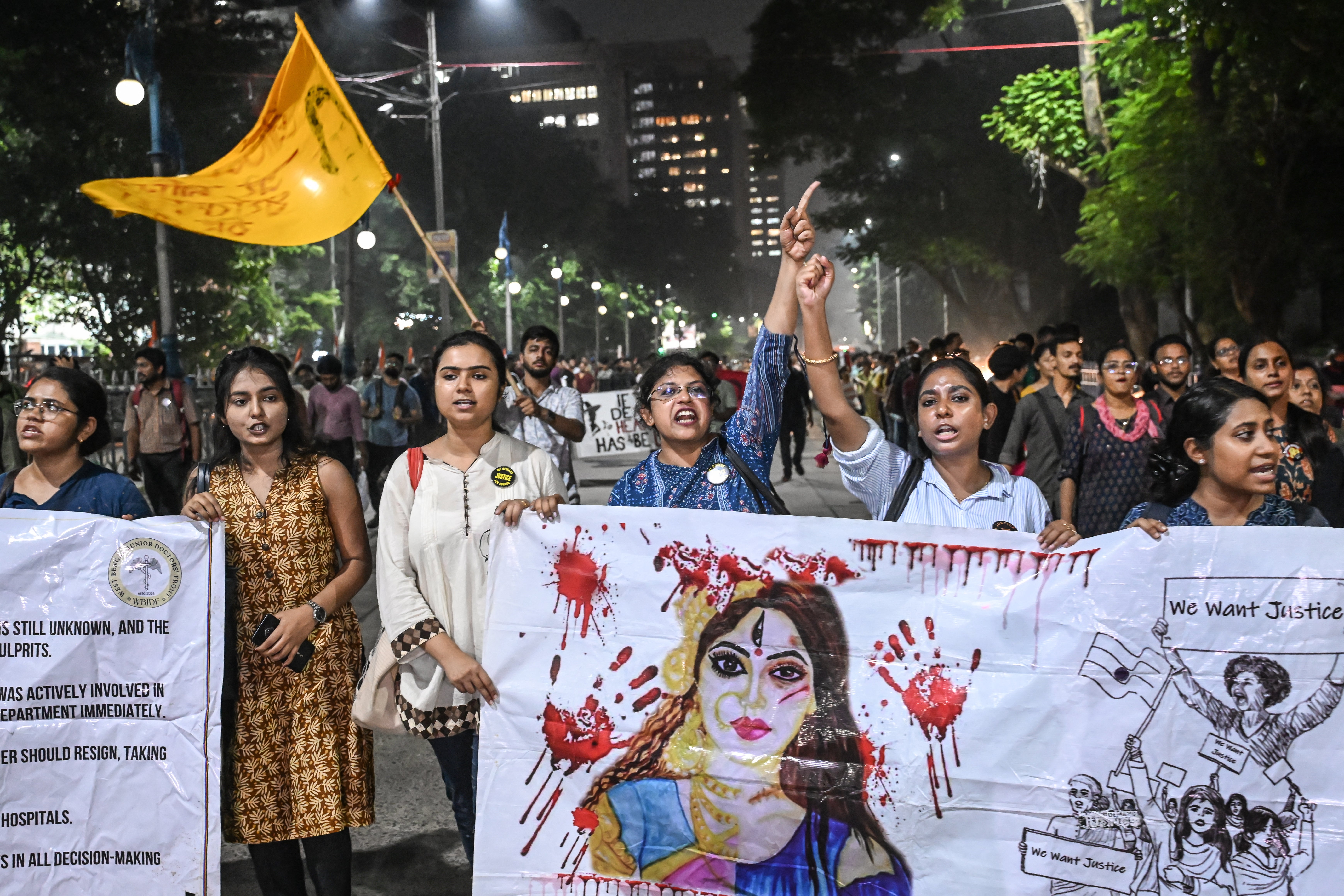 Activists and medical professionals shout slogans during a protest march to condemn the rape and murder of a doctor, in Kolkata on 4 October