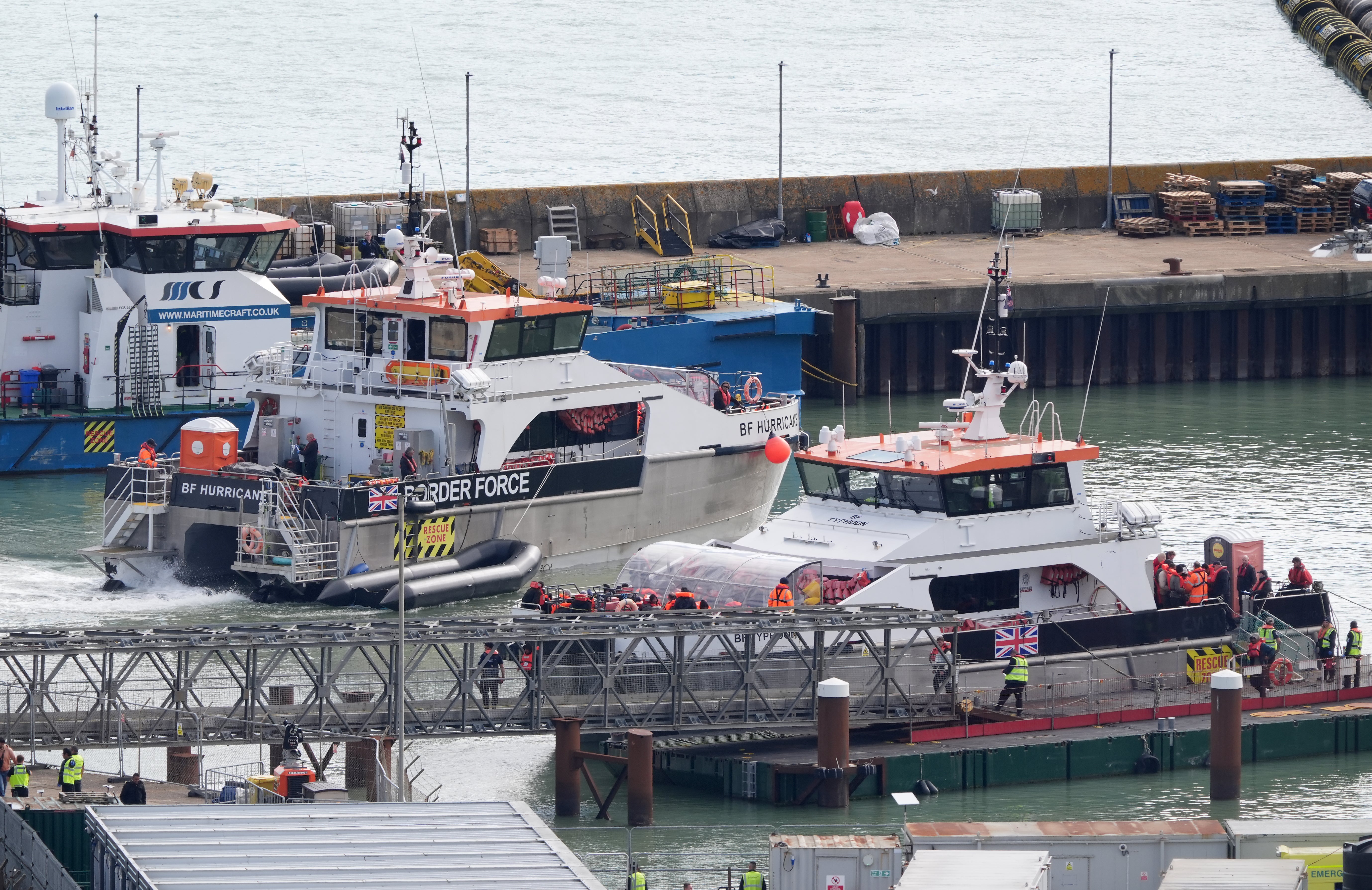 Groups of people thought to be migrants are brought in to Dover, Kent, on Friday onboard Border Force vessels