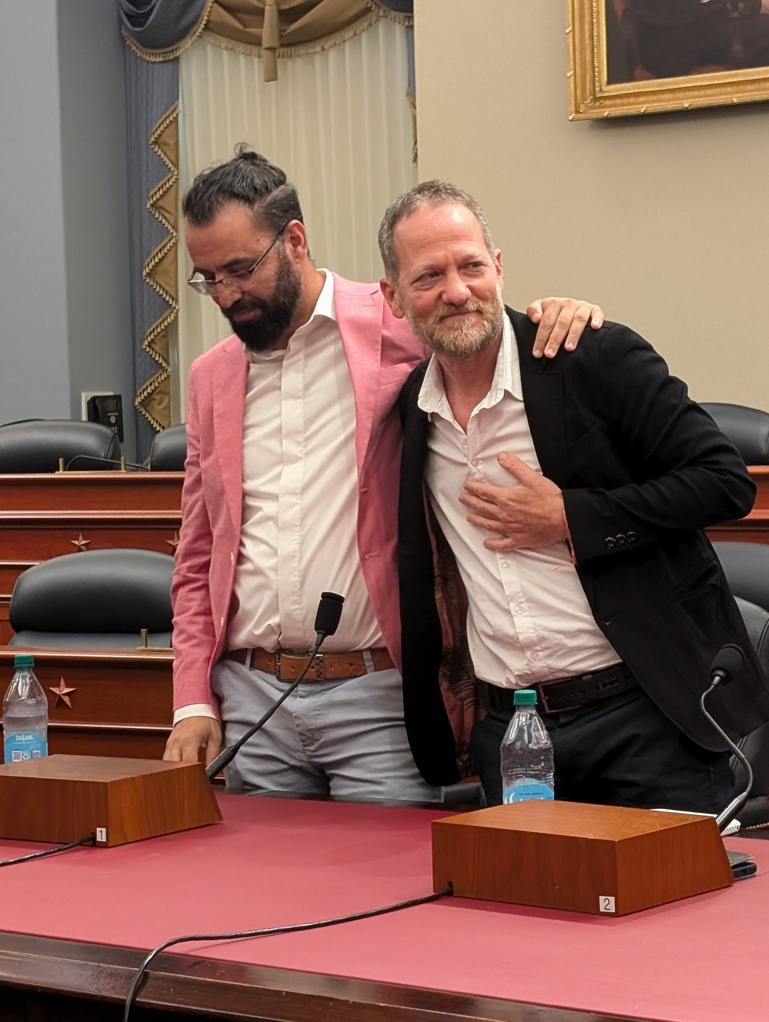 Aziz Abu Sarah and Maoz Inon embrace after campaigning for peace