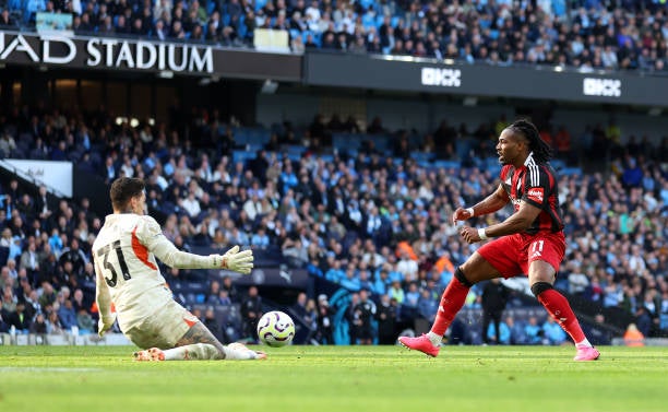 Ederson saves at the feet of Fulham winger Adama Traore