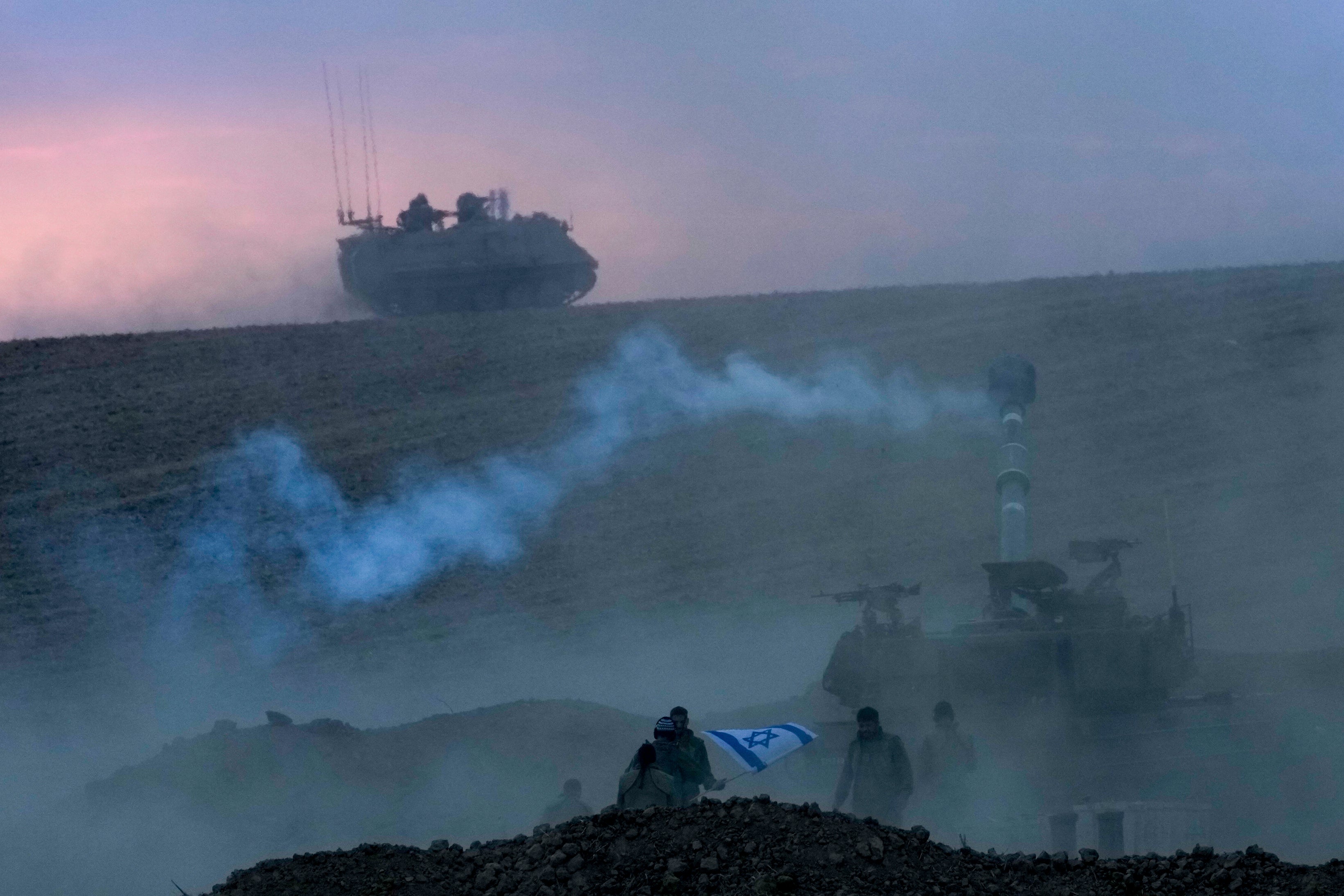 An Israeli mobile artillery unit fires a shell from southern Israel toward the Gaza Strip, in a position near the Israel-Gaza border