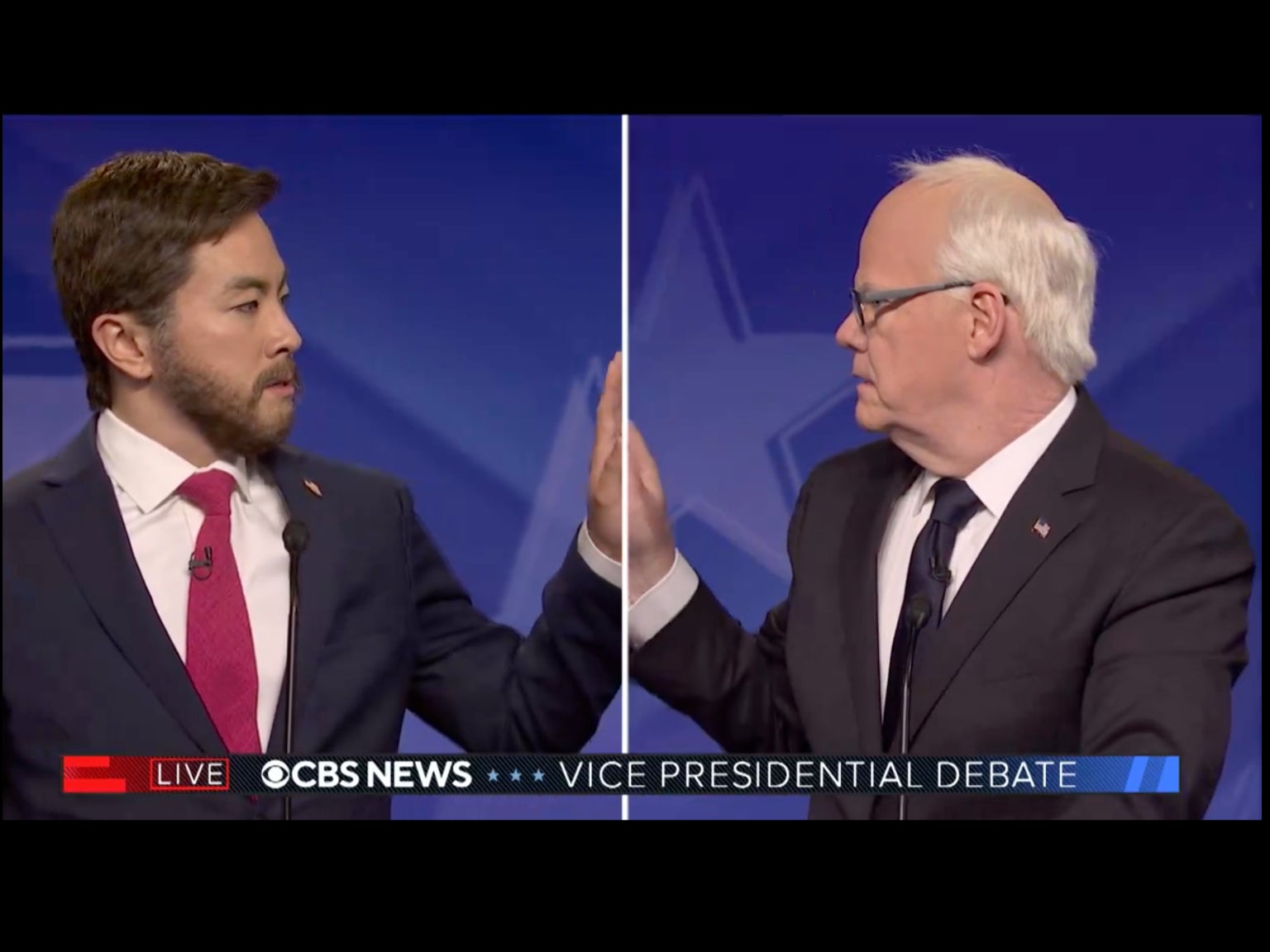 Bowen Yang’s JD Vance, left, and Jim Gaffigan’s Tim Walz, right, share a tender moment during a parody of the vice presidential debate on “Saturday Night Live” on October 5.