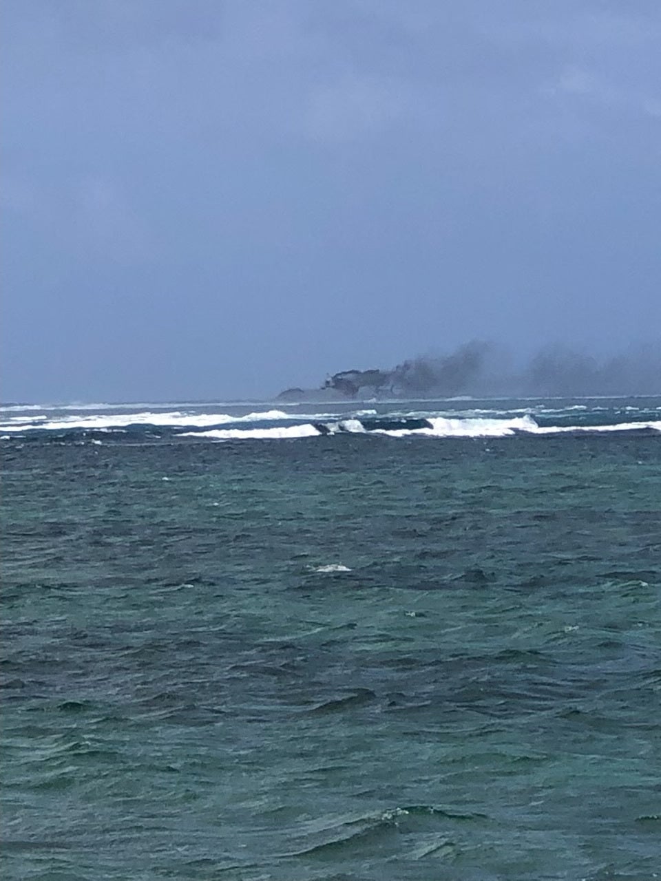 A view of a New Zealand Navy vessel on fire, as seen from Tafitoala, Samoa, 6 October 2024, in this picture obtained from social media