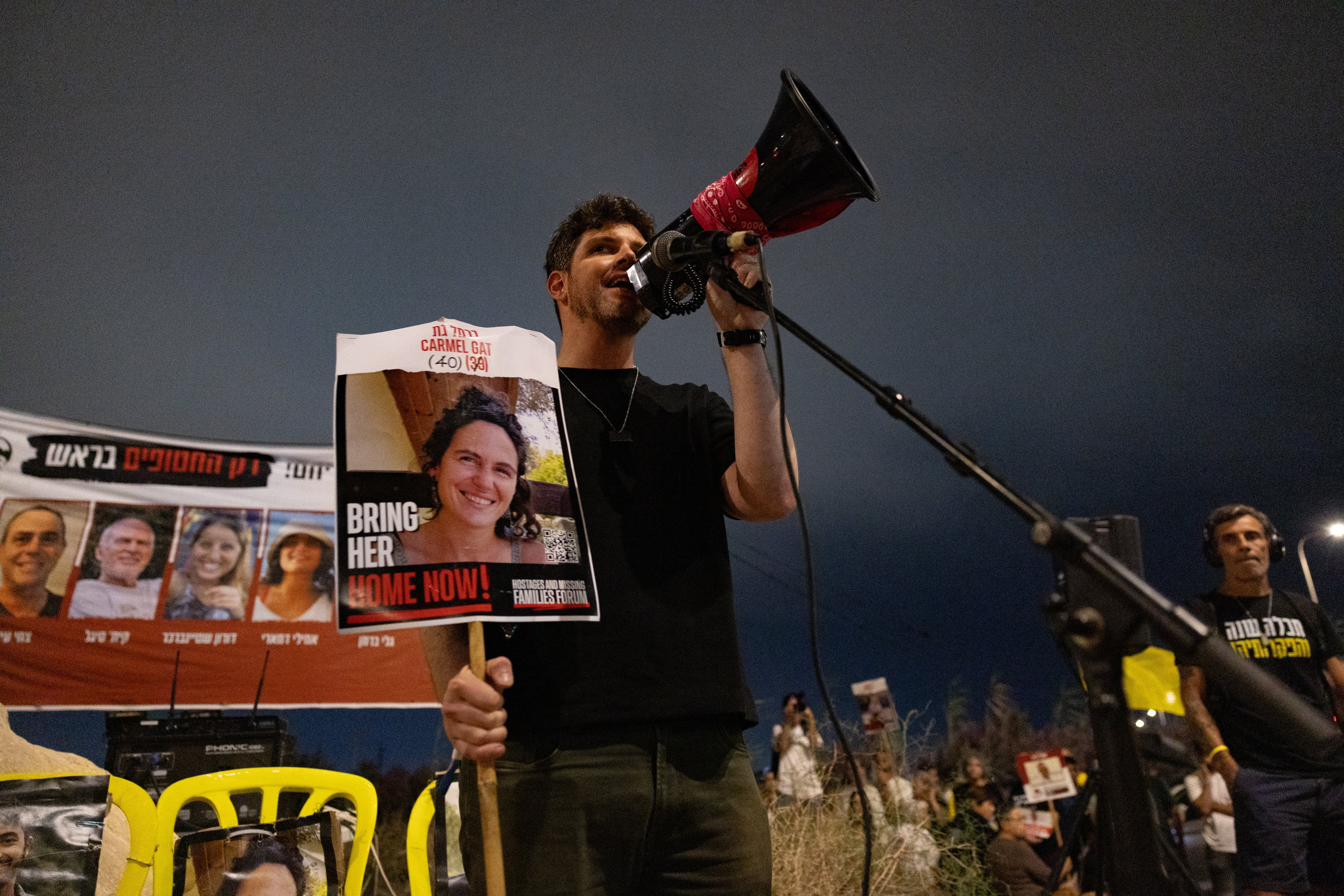 Gil Dickmann speaks about his cousin Carmel Gat, 41, at a rally in southern Israel on 5 October