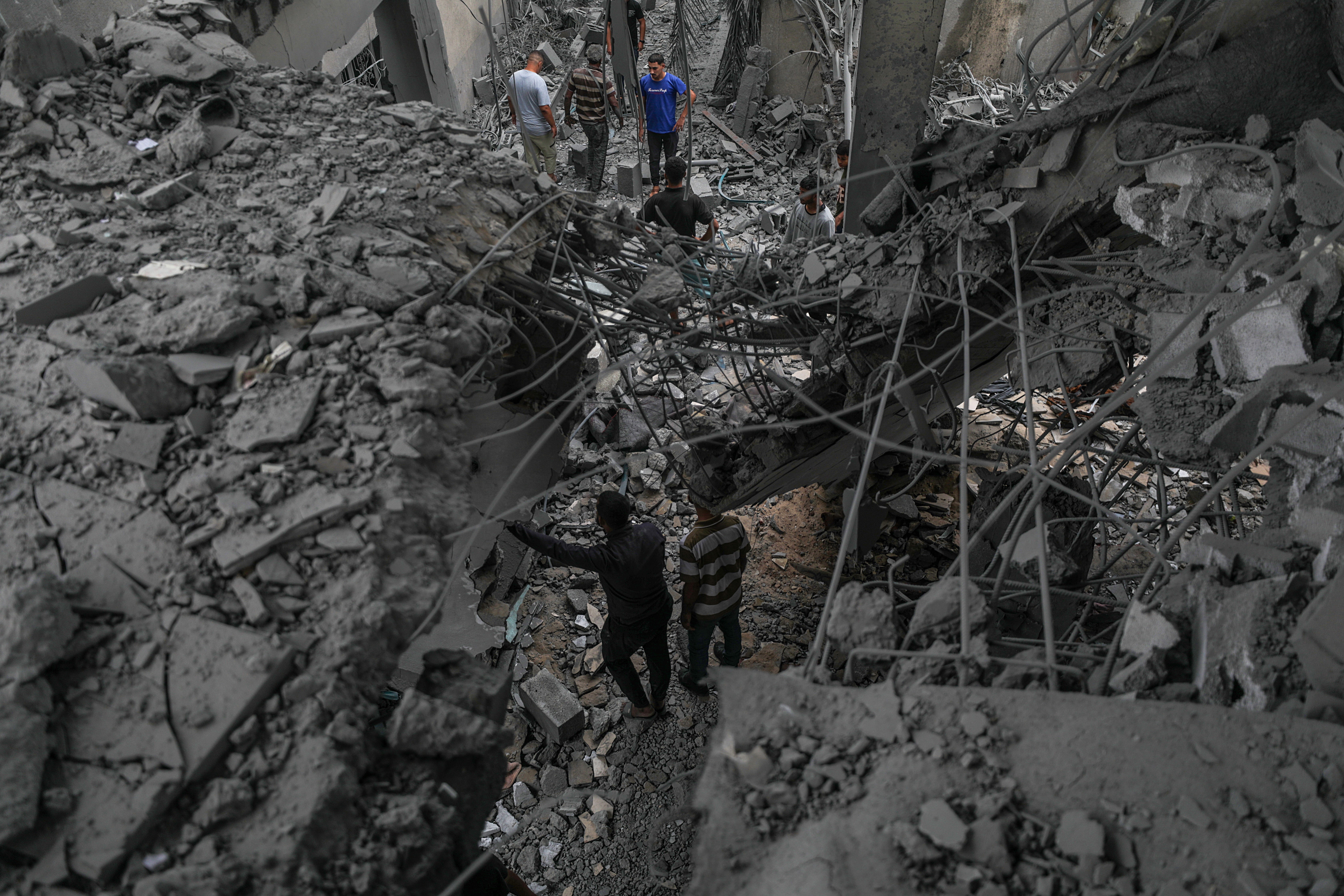 Palestinians inspect the rubble of the destroyed Al Aqsa Martyrs Mosque following an Israeli airstrike in Deir Al Balah, central Gaza Strip