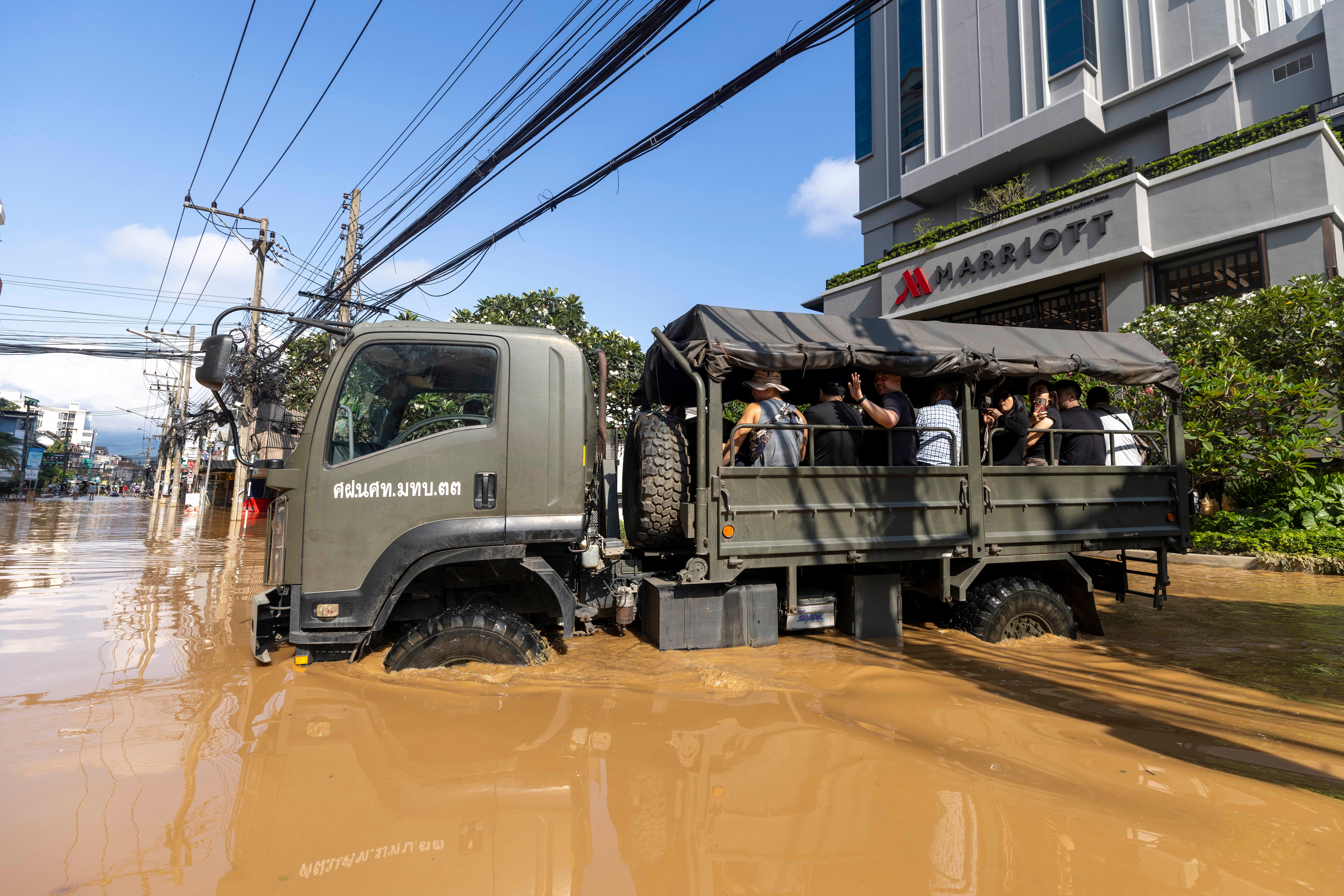 Thailand FloodsTourists evacuate from a flood-hit area in Chiang Mai Province, Thailand, Sunday