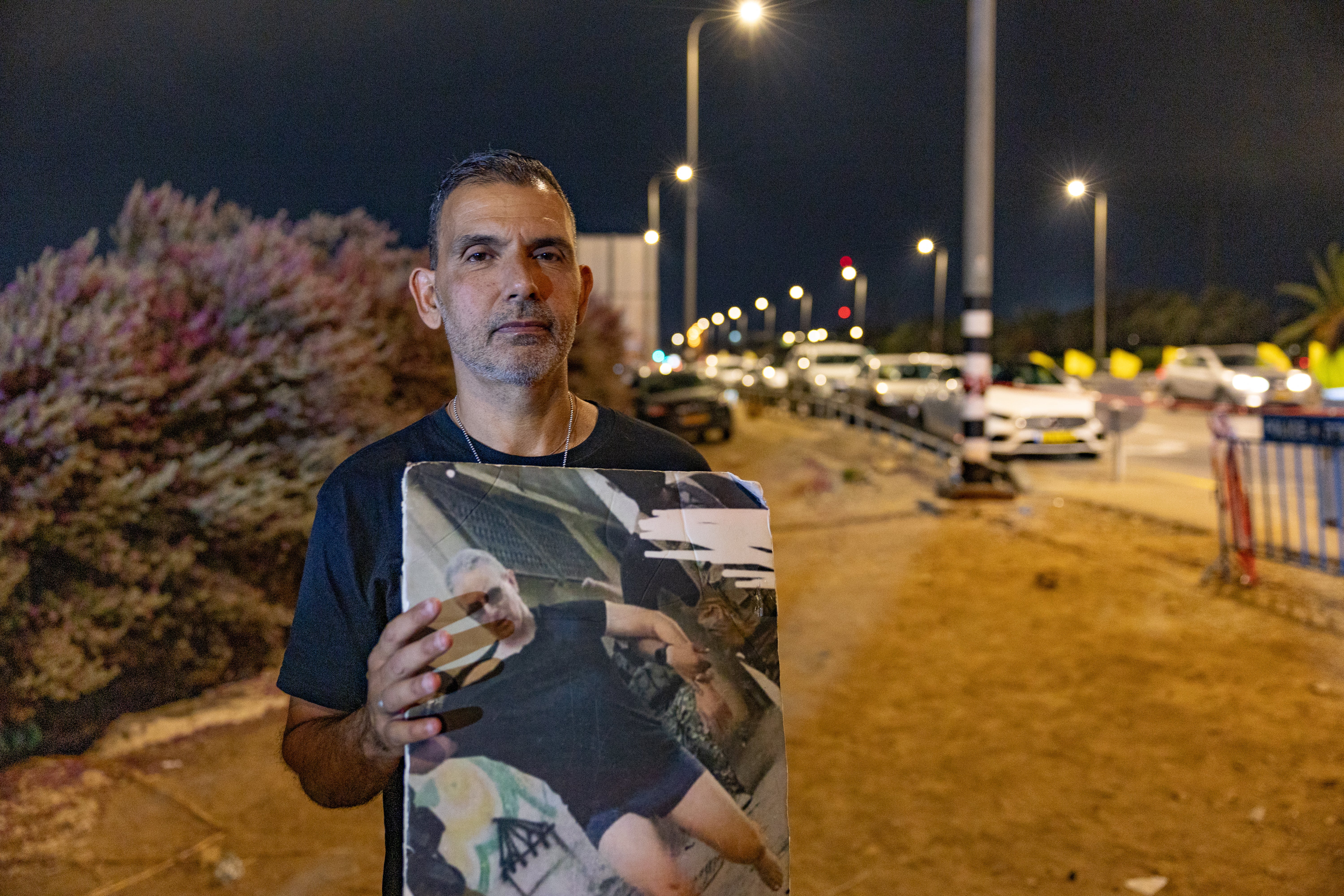 Kobi Ben Ami, 54, holds a picture of his brother of Ohad, 55, who is still being held hostage in the Gaza Strip by Hamas