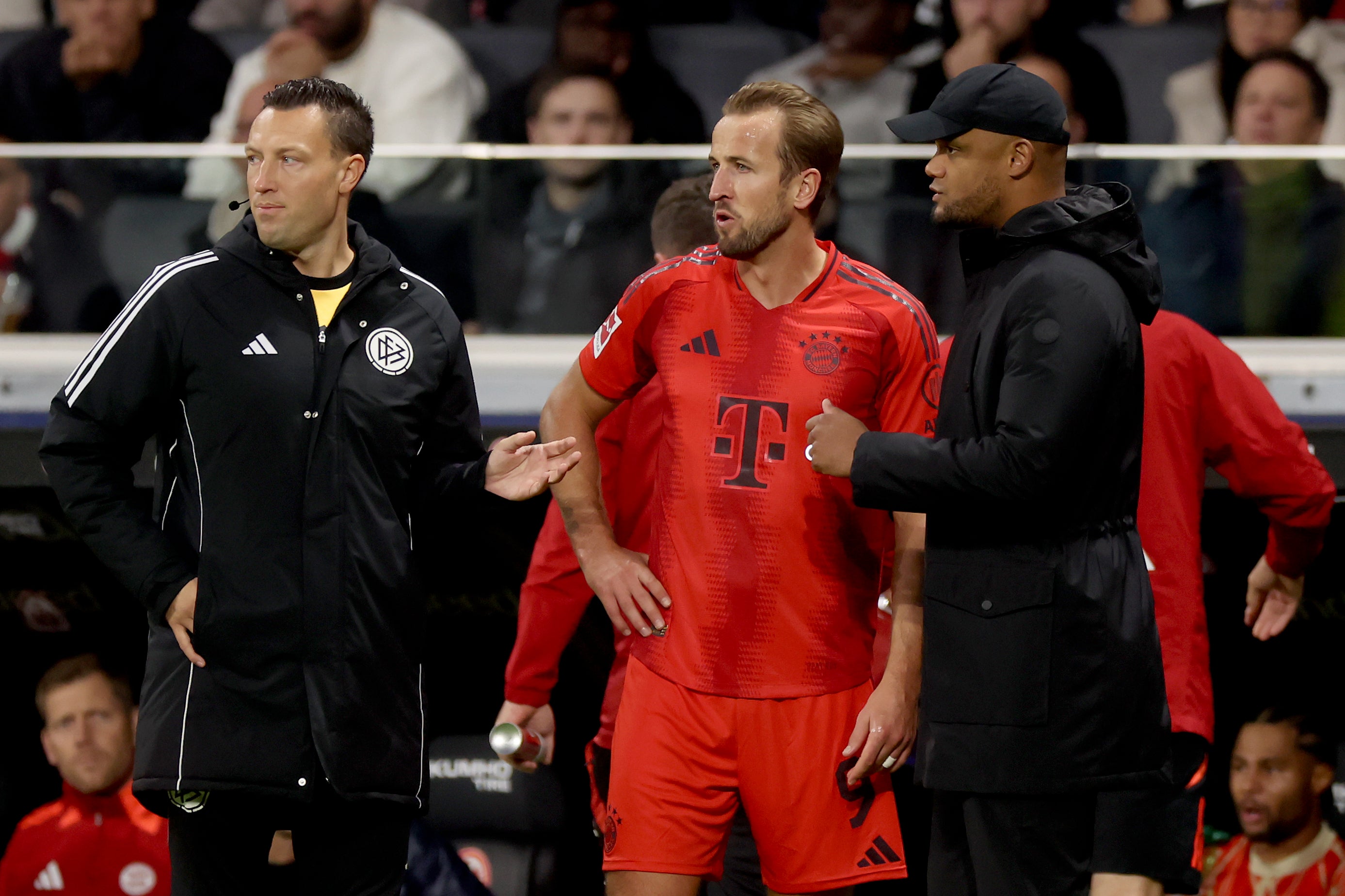 Harry Kane (centre) was substituted by Bayern boss Vincent Kompany (right)