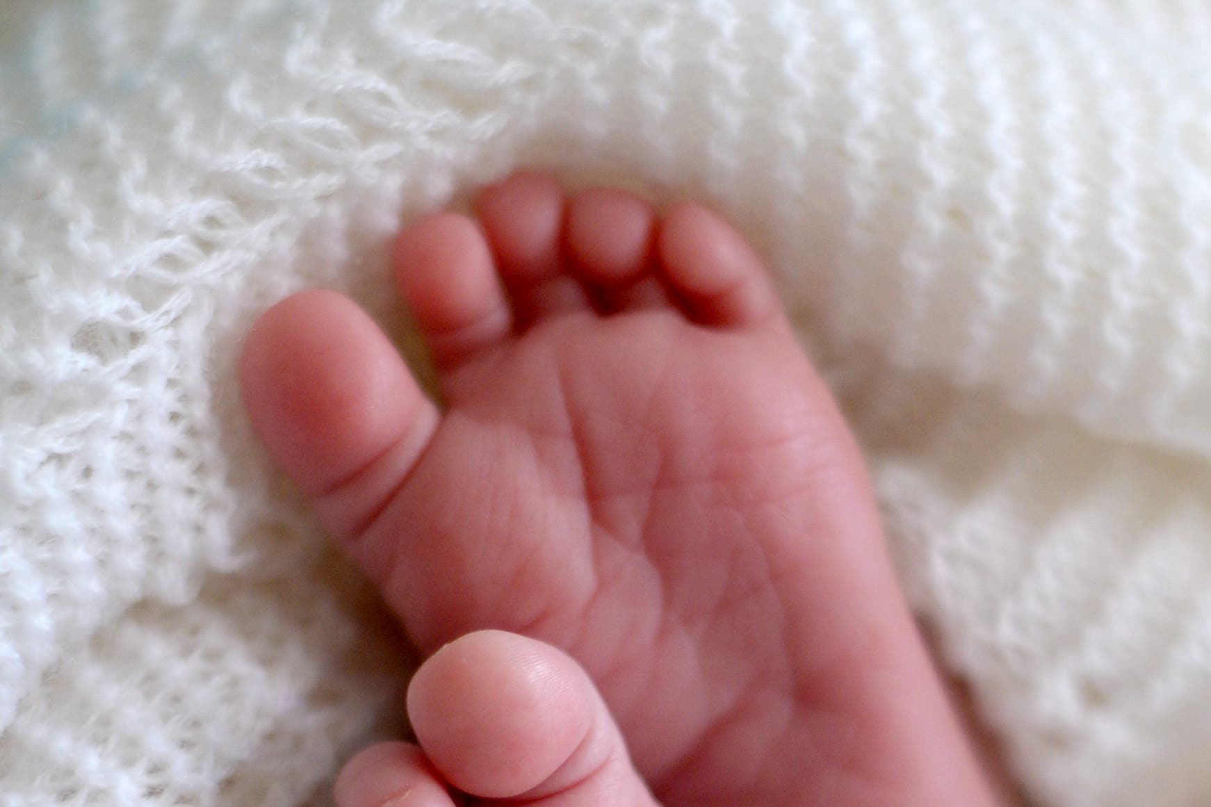 A new born baby’s feet (Andrew Matthews/PA)