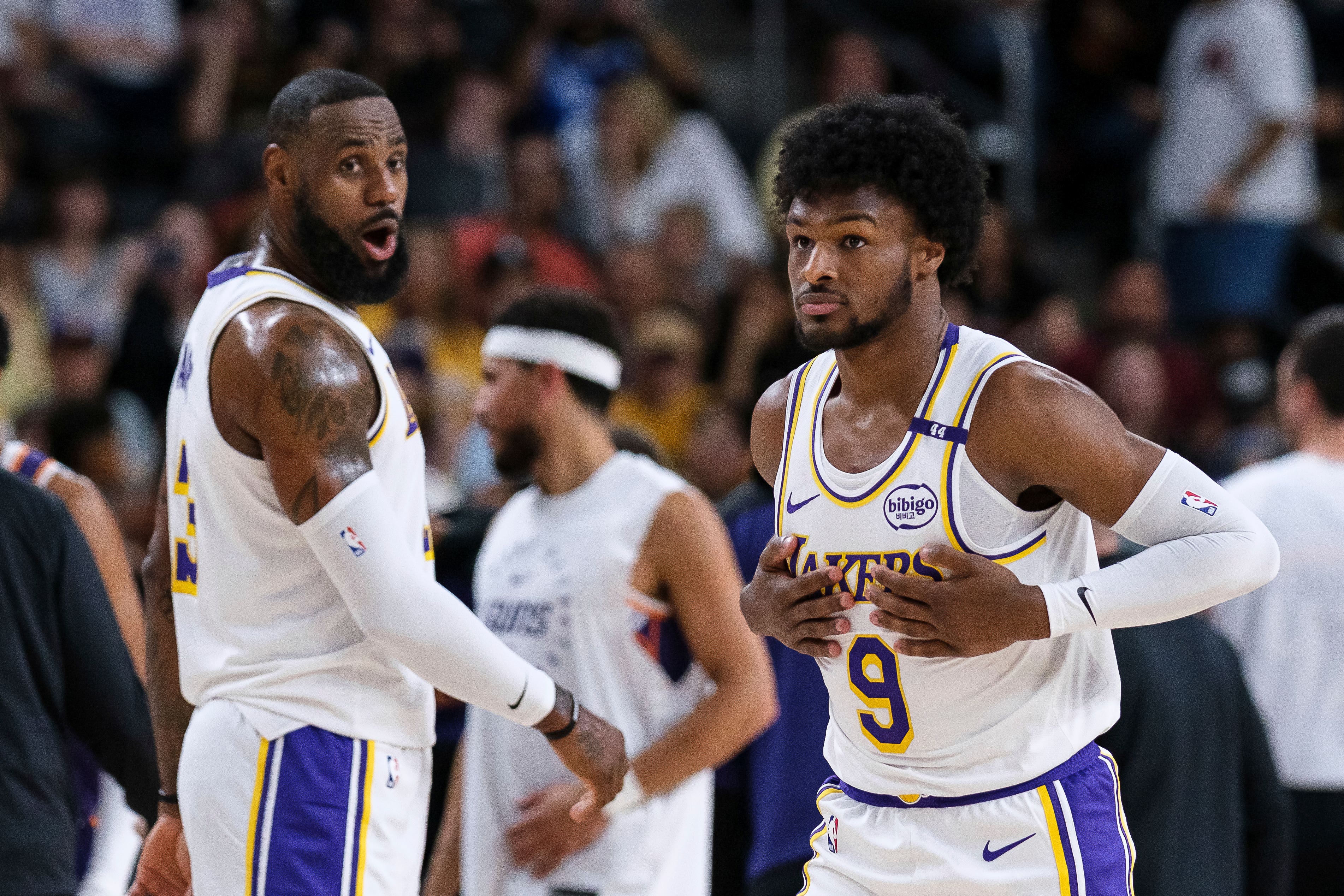 Los Angeles Lakers guard Bronny James, right, steps onto the court with his father LeBron James in Palm Desert, California (William Liang/AP)