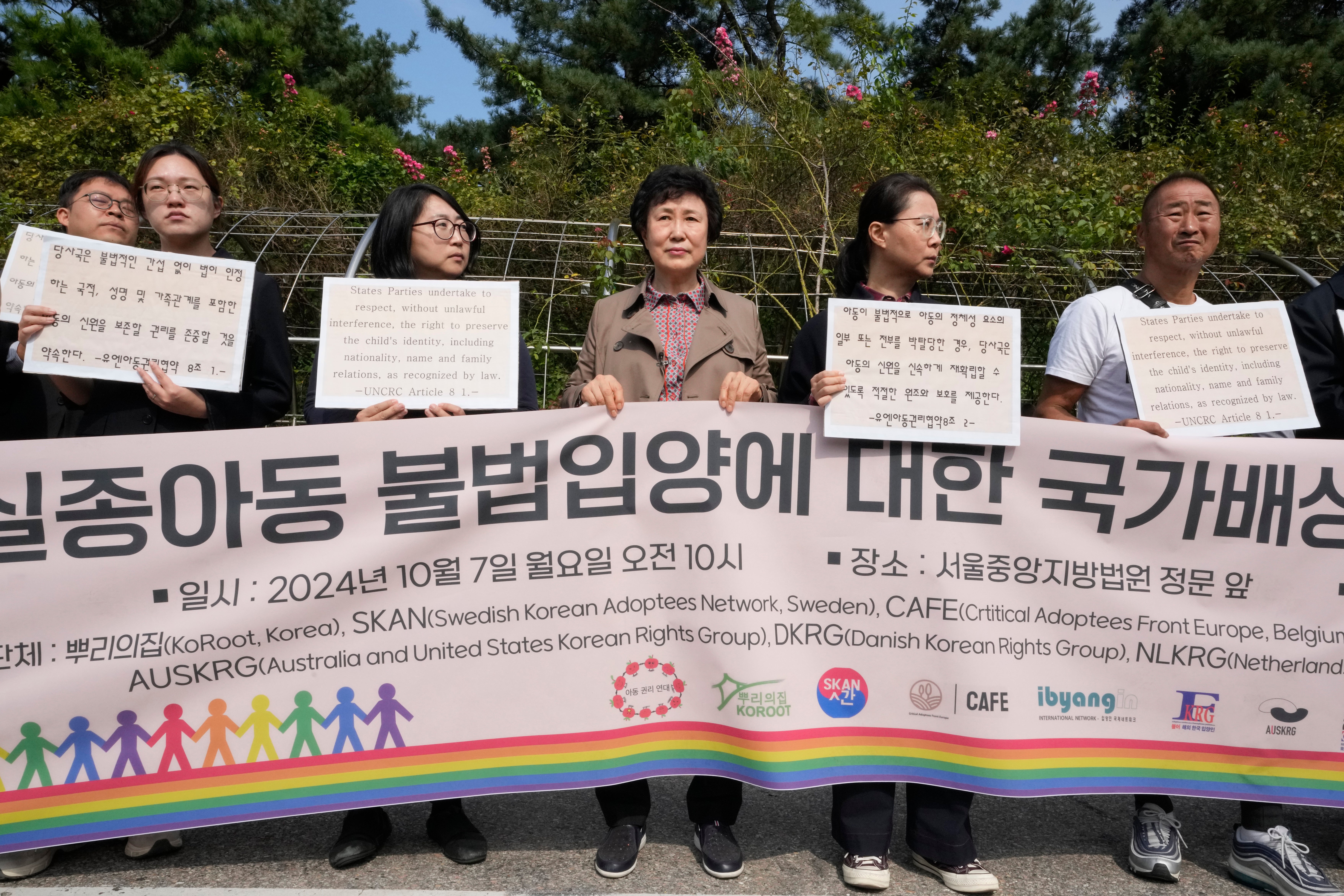 Han Tae-soon, center, attends a press conference in front of the Seoul Central District Court in Seoul, South Korea