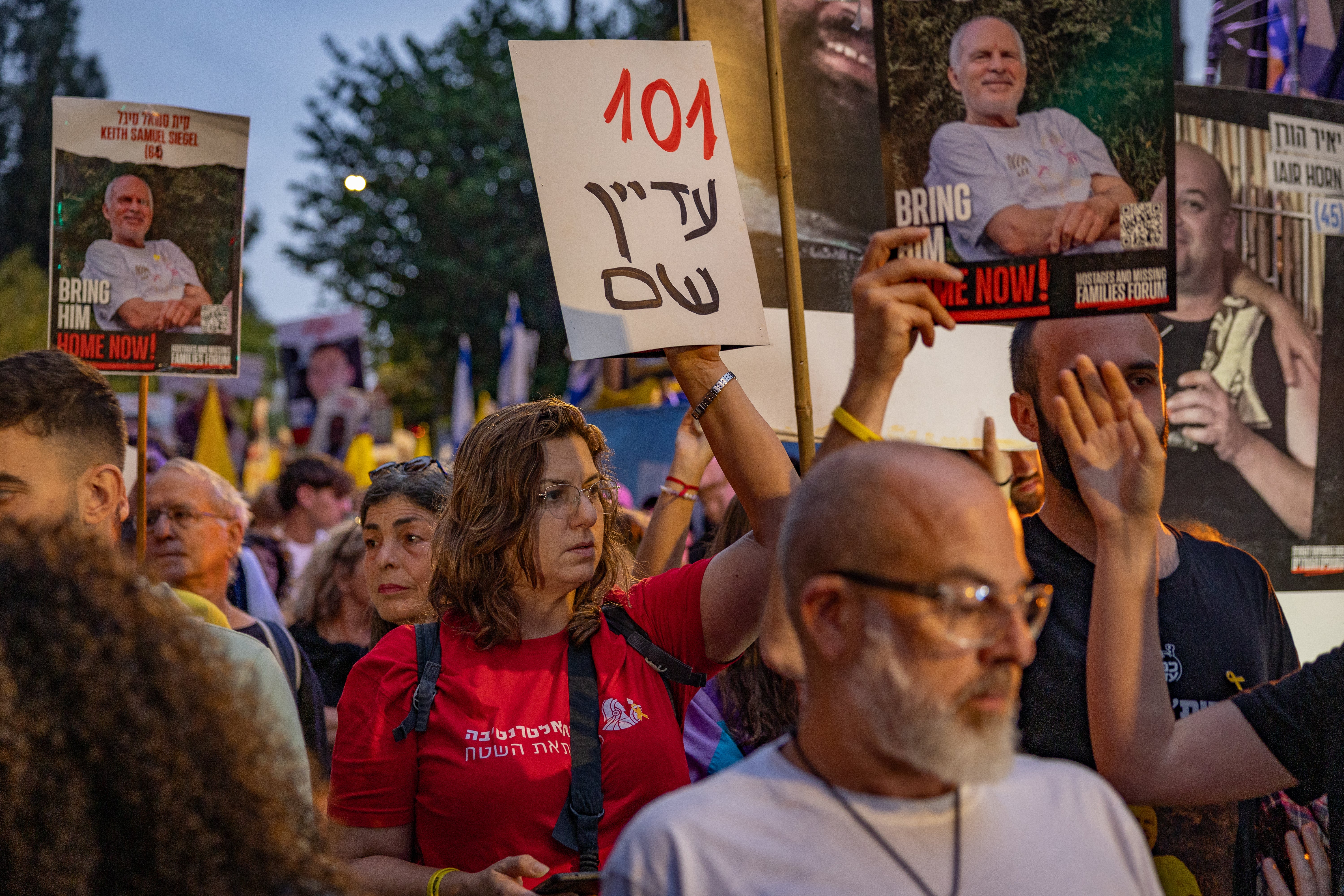 A woman holds up a placard calling for the release of the 101 hostages still held by Hamas in Gaza