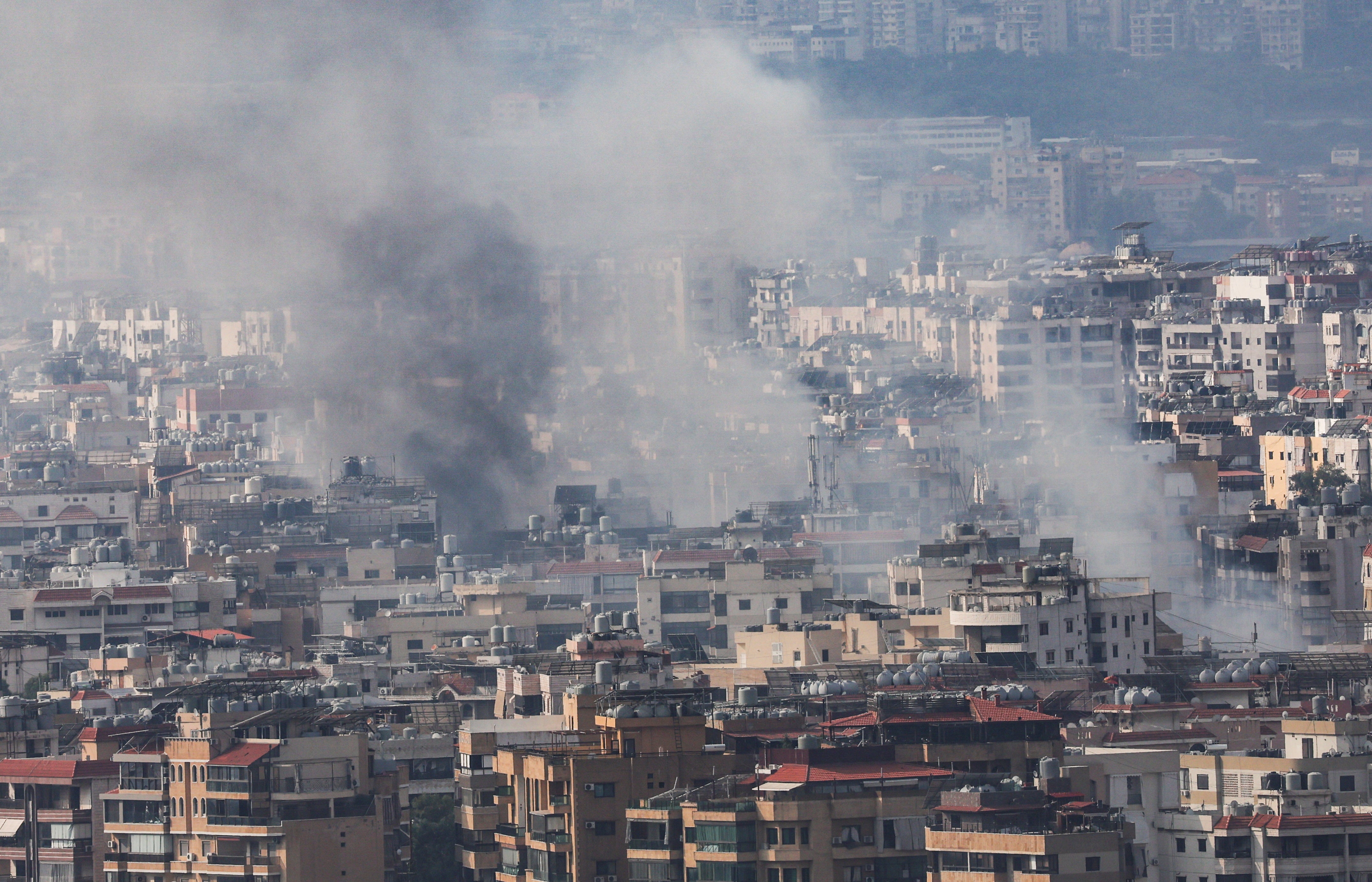 Smoke rises over Dahiyeh in Beirut’s southern suburbs after overnight Israeli air strikes as seen from Sin El Fil, Lebanon