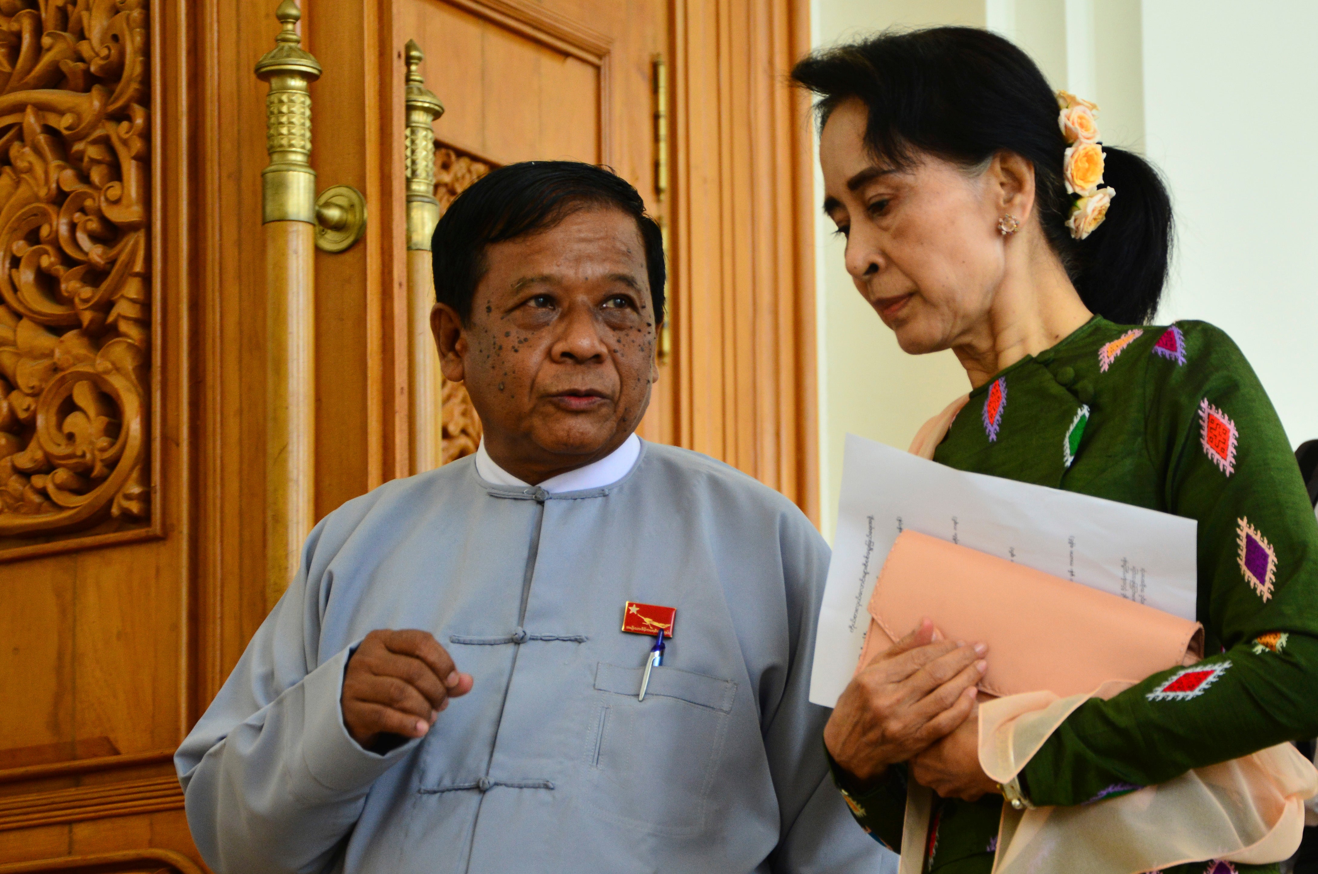 Zaw Myint Maung, left, an imprisoned politician and a close colleague of Myanmar’s ousted leader Aung San Suu Kyi, right, talks with Suu Kyi at Parliament in Naypyitaw, Myanmar, on 23 July 2015