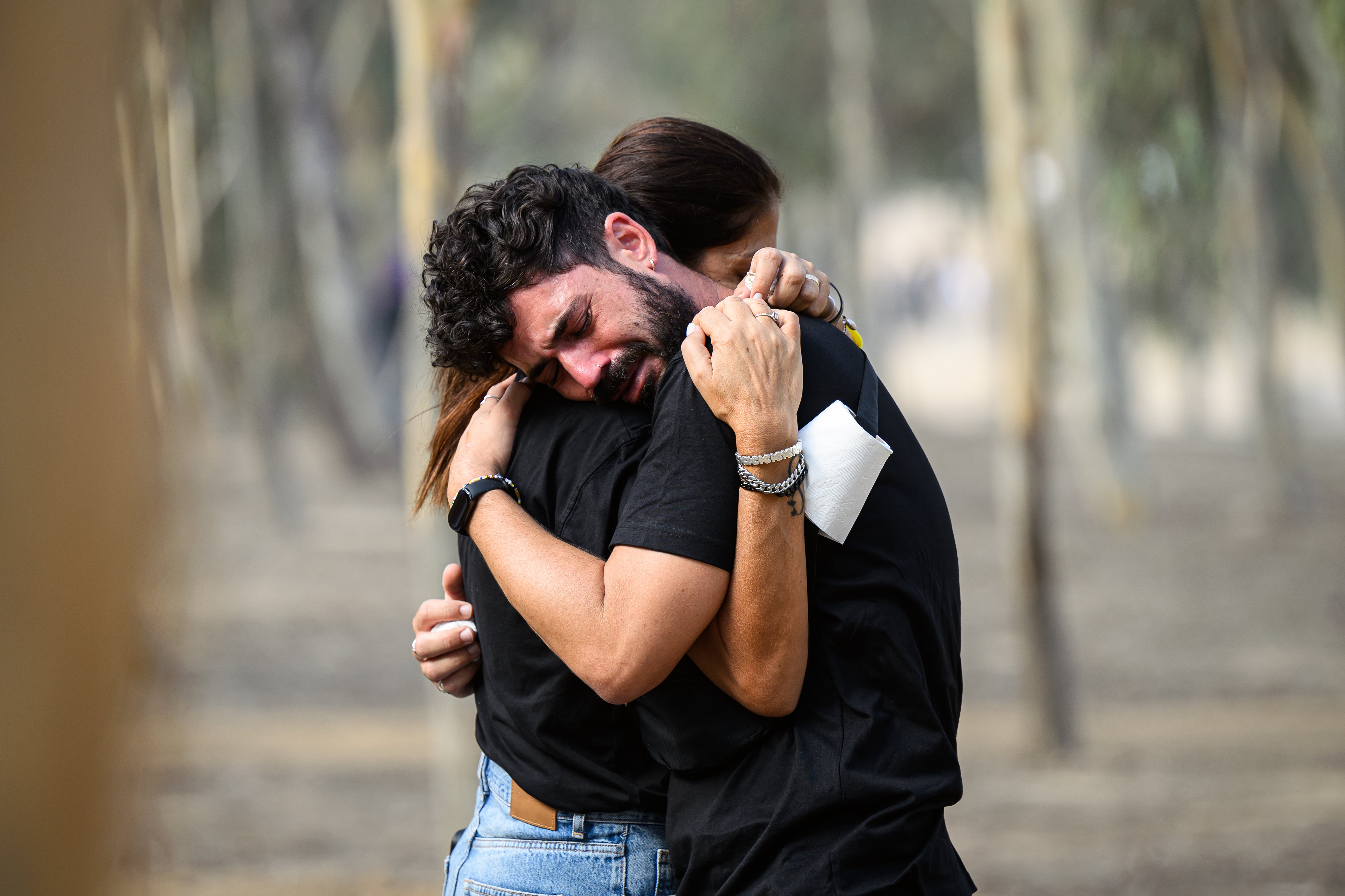 A man and a woman embrace as family members and friends of the lost and kidnapped gather at the site of the Nova Festival to mark the one year anniversary of the attacks by Hamas in Re’im, Israel