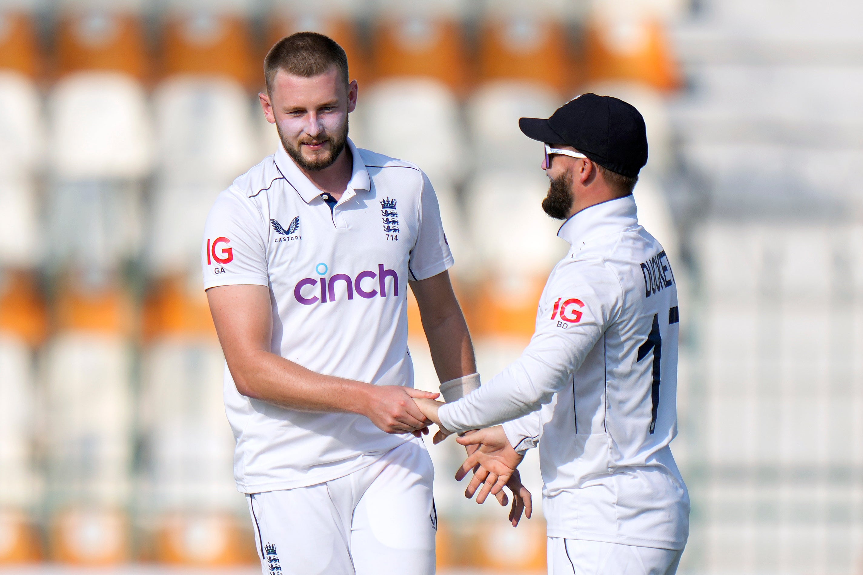 Gus Atkinson, left, was among the wickets for England (Anjum Naveed/AP)