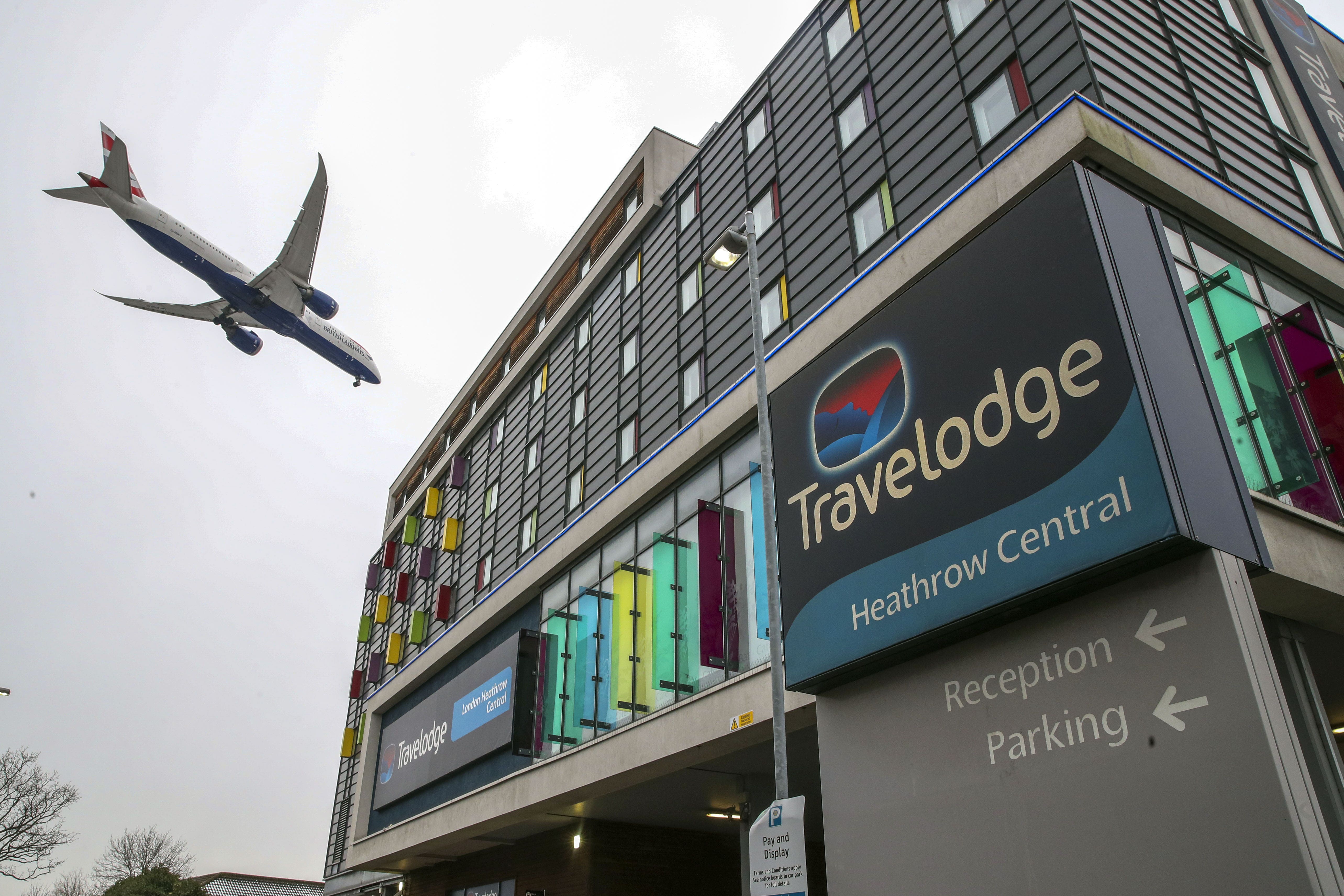 A plane passes over the Travelodge Hotel at Heathrow (Steve Parsons/PA)