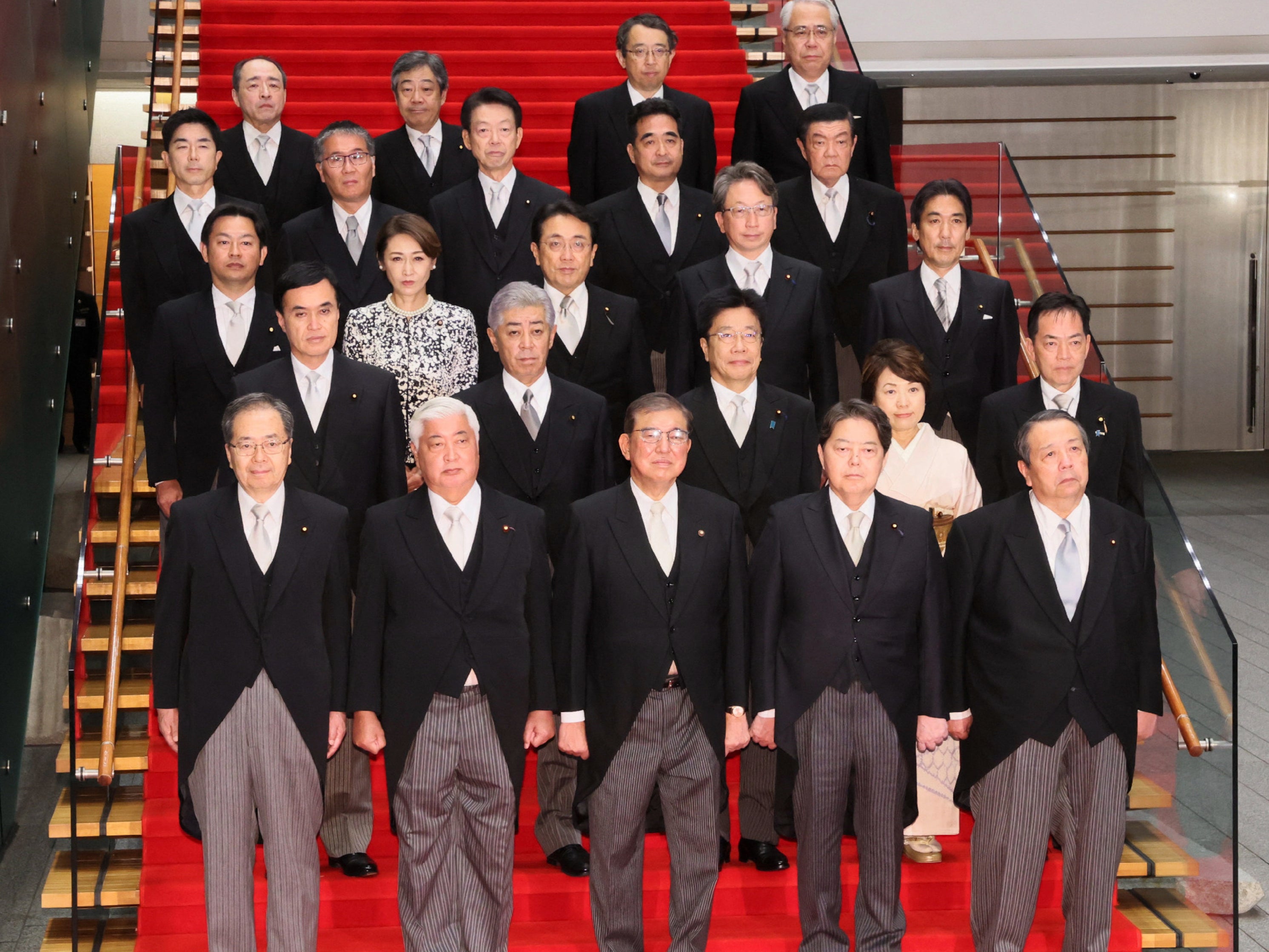 This picture taken on 1 October 2024 shows Japan’s new prime minister Shigeru Ishiba (front C) posing during a photo session with the members of his cabinet at the prime minister’s official residence in Tokyo