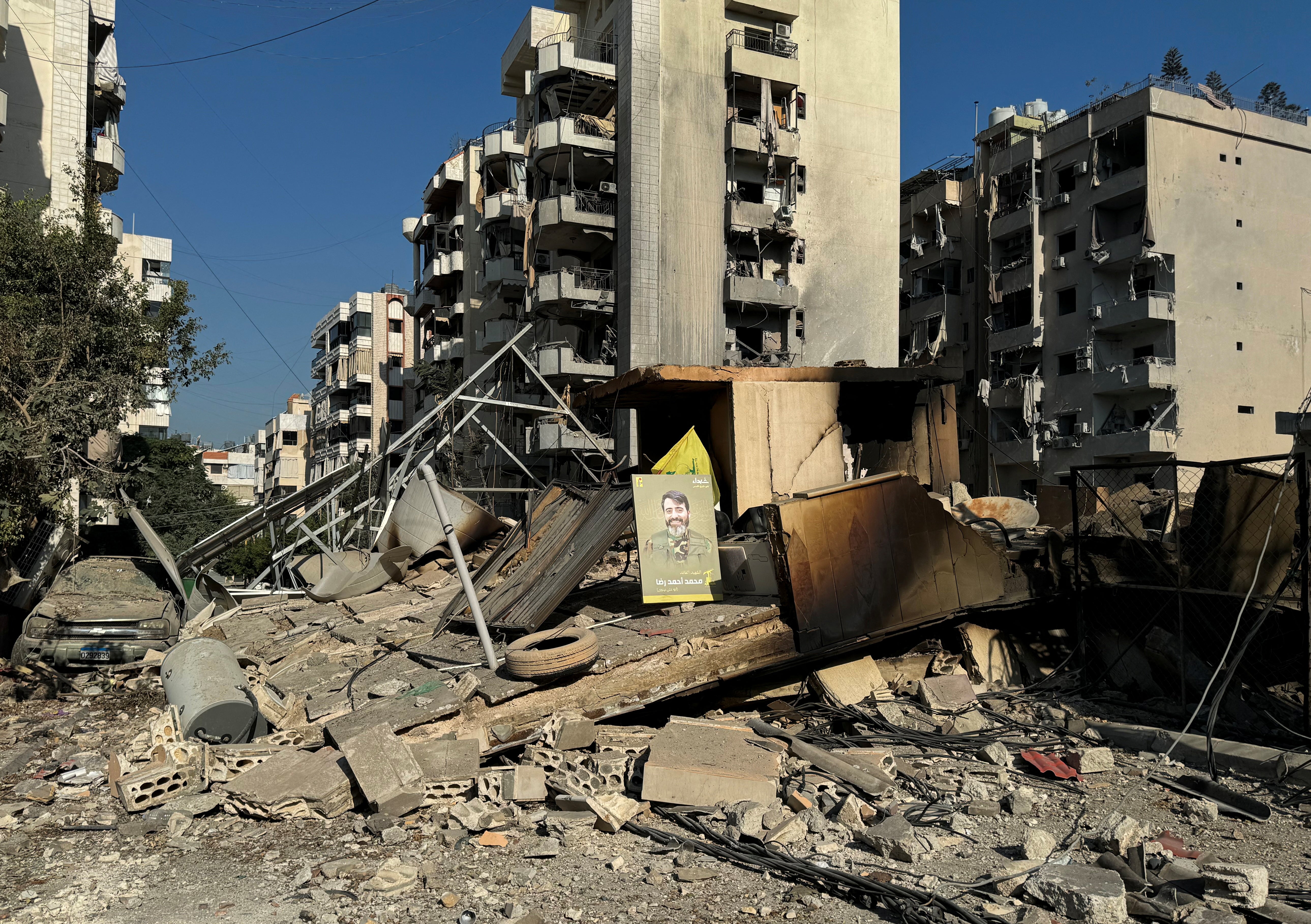 A Hezbollah ‘martyr’ poster sits among the rubble of a southern Beirut suburb following an overnight Israeli airstrike