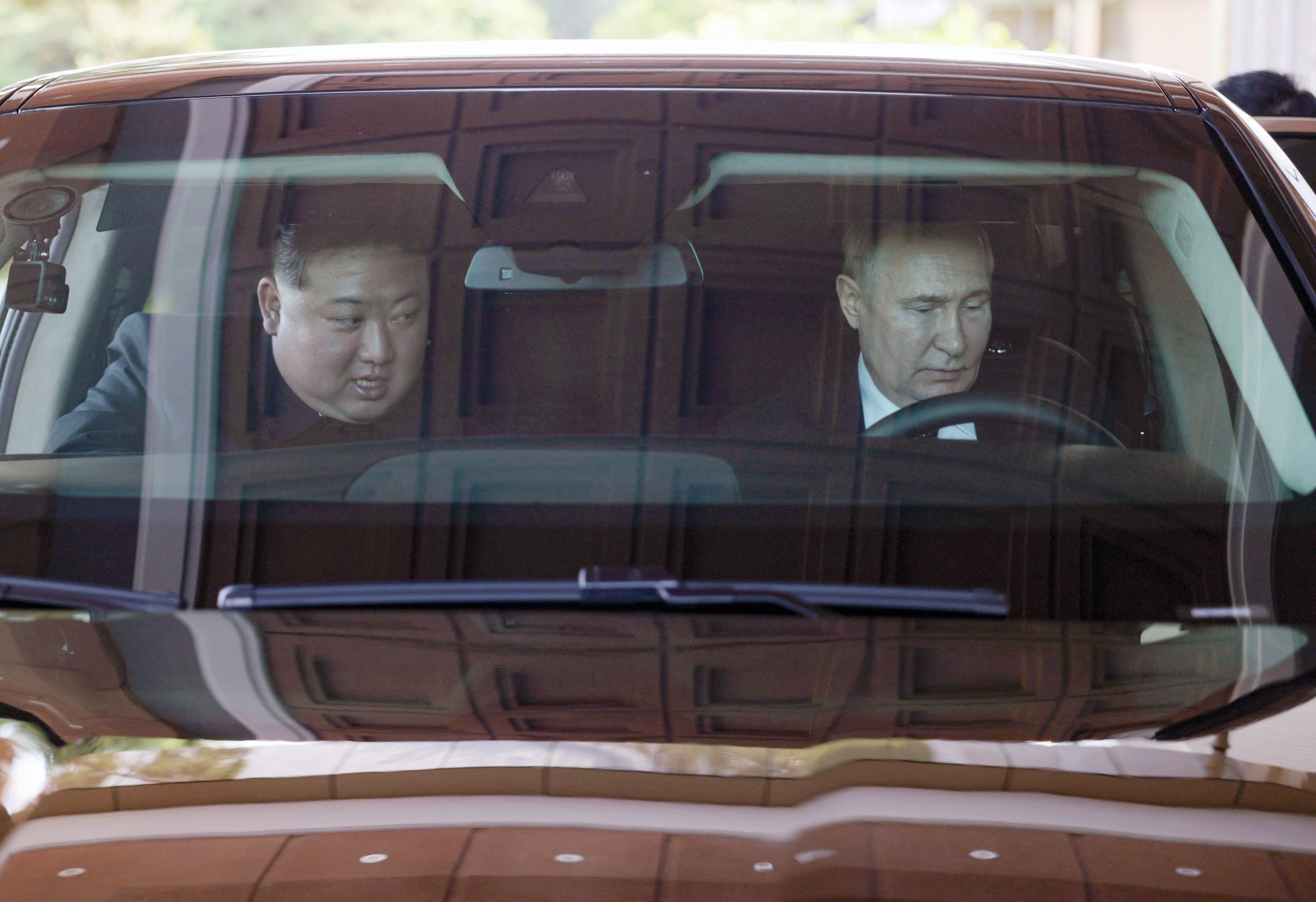 Vladimir Putin and Kim Jong-un drive an Aurus car in Pyongyang in June