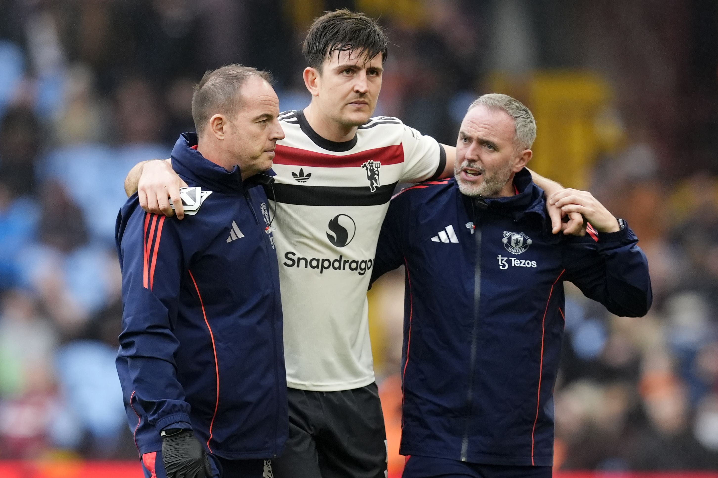 Harry Maguire, centre, is helped from the pitch (Nick Potts/PA)