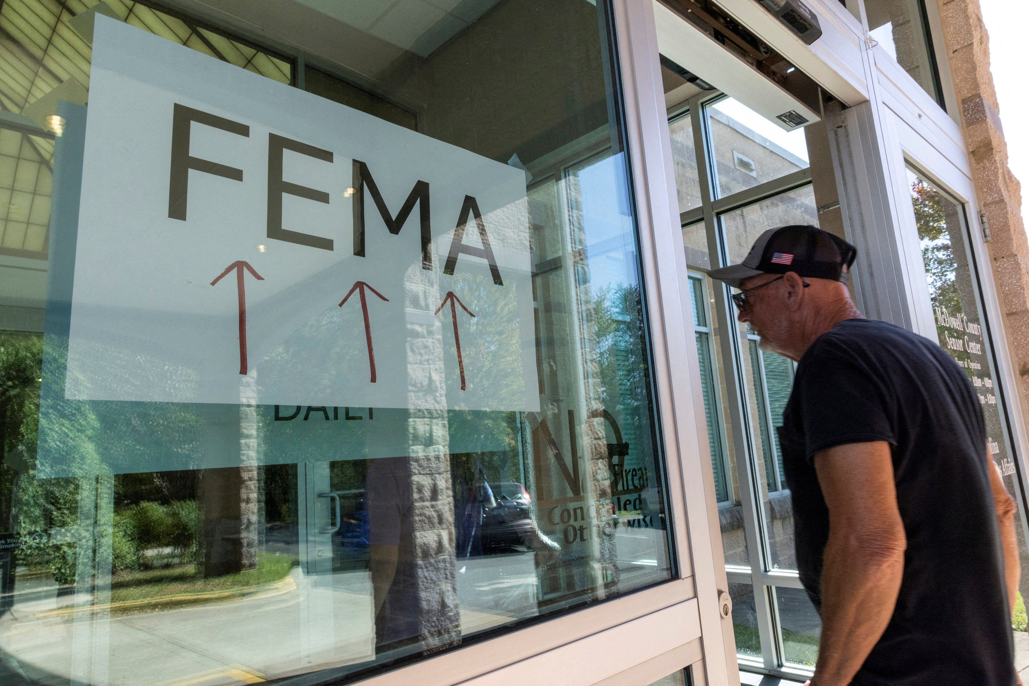 A man enters a FEMA station in western North Carolina on Saturday. FEMA has provided more than $210 million to survivors of Hurricane Helene across six Southeast states, but the agency faces dwindling funding and political rumors