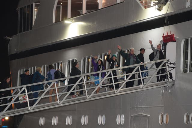 <p>Passengers wave as they finally make their way onto Odyssey</p>