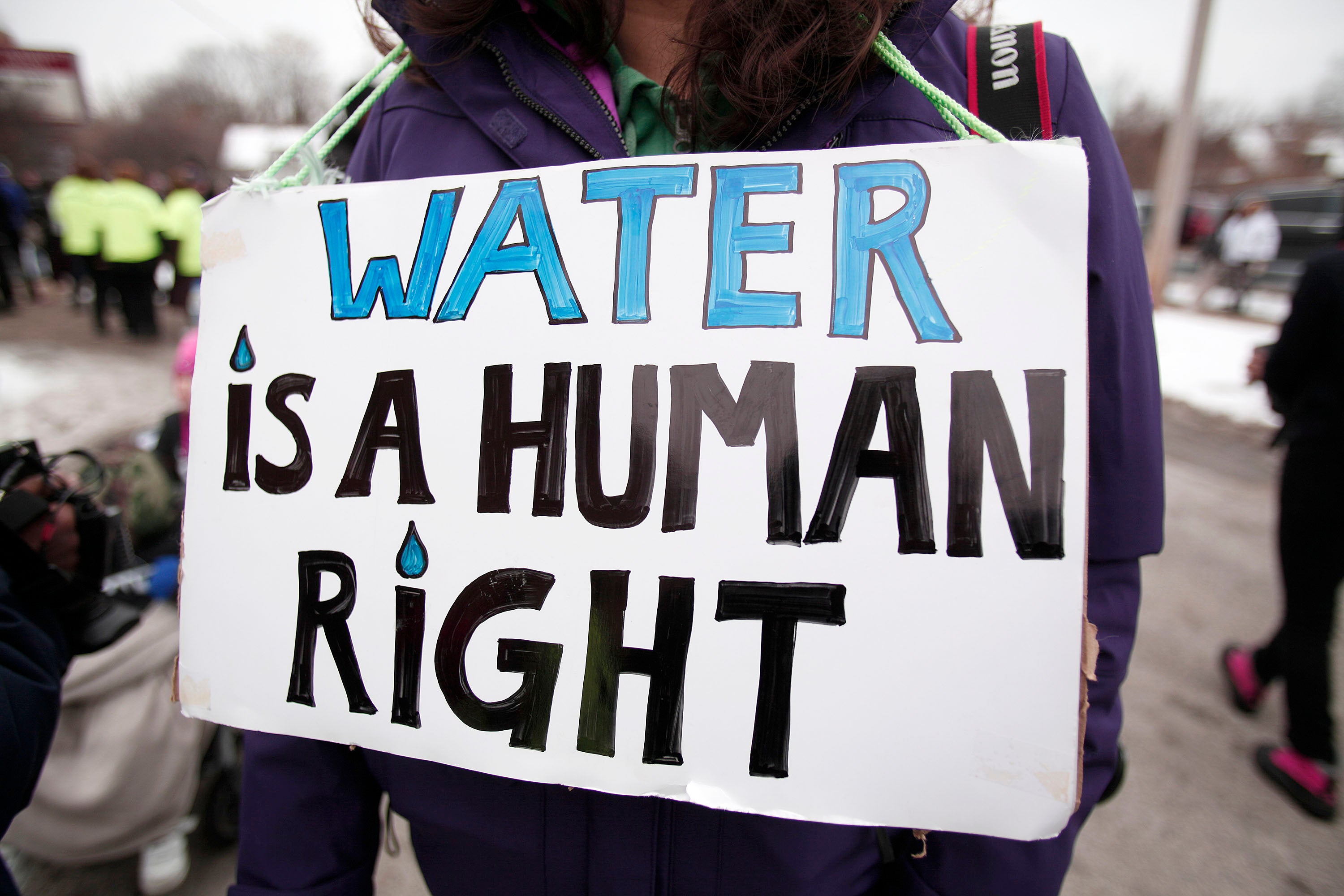 A demonstrator holds a sign that reads, “water is a human right” during a march to highlight the water crisis in Flint, Michigan in 2016. The EPA has now announced a push to remove nearly all lead pipes within 10 years