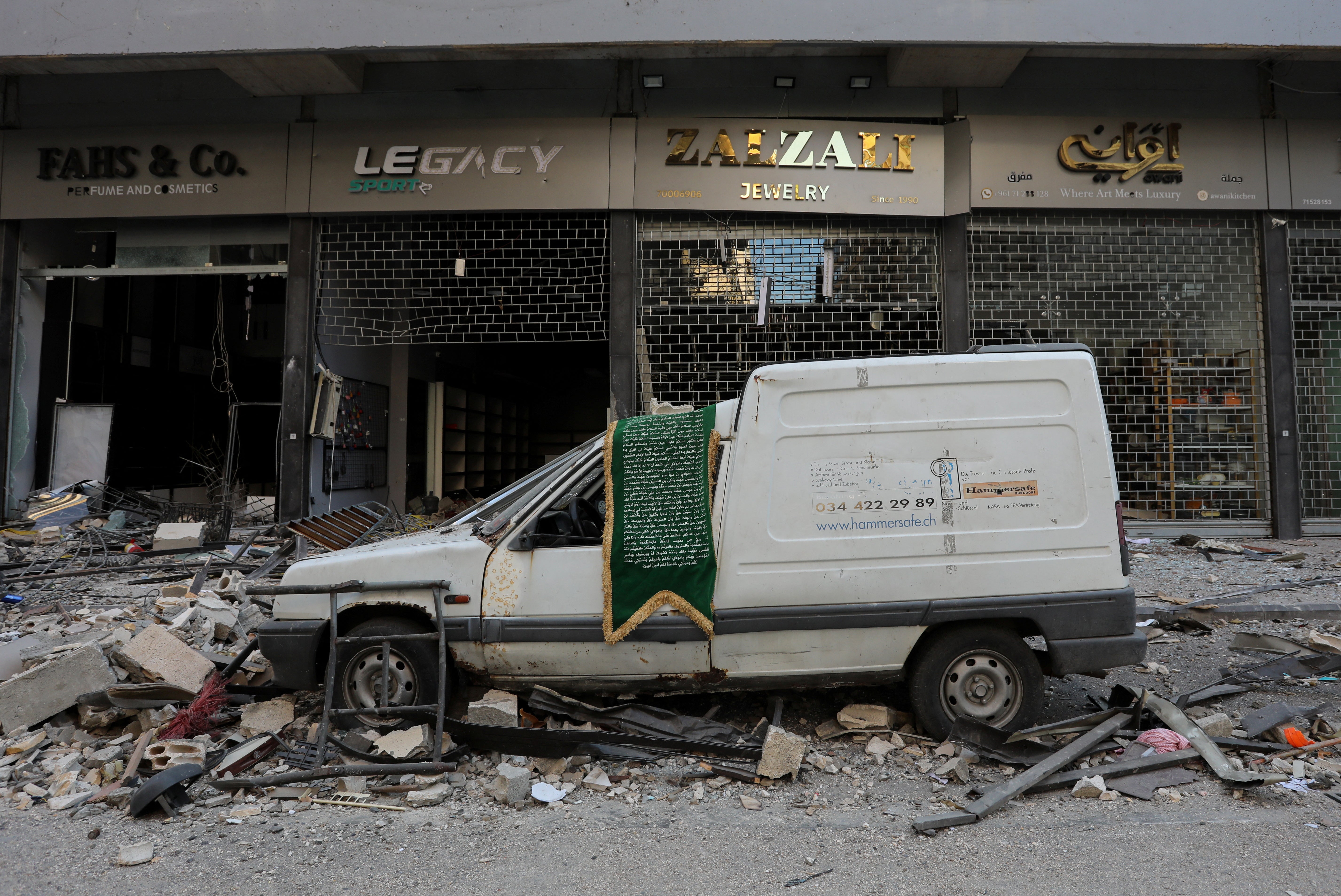 The streets of Beirut’s southern suburbs are lined with debris and battered shopfront