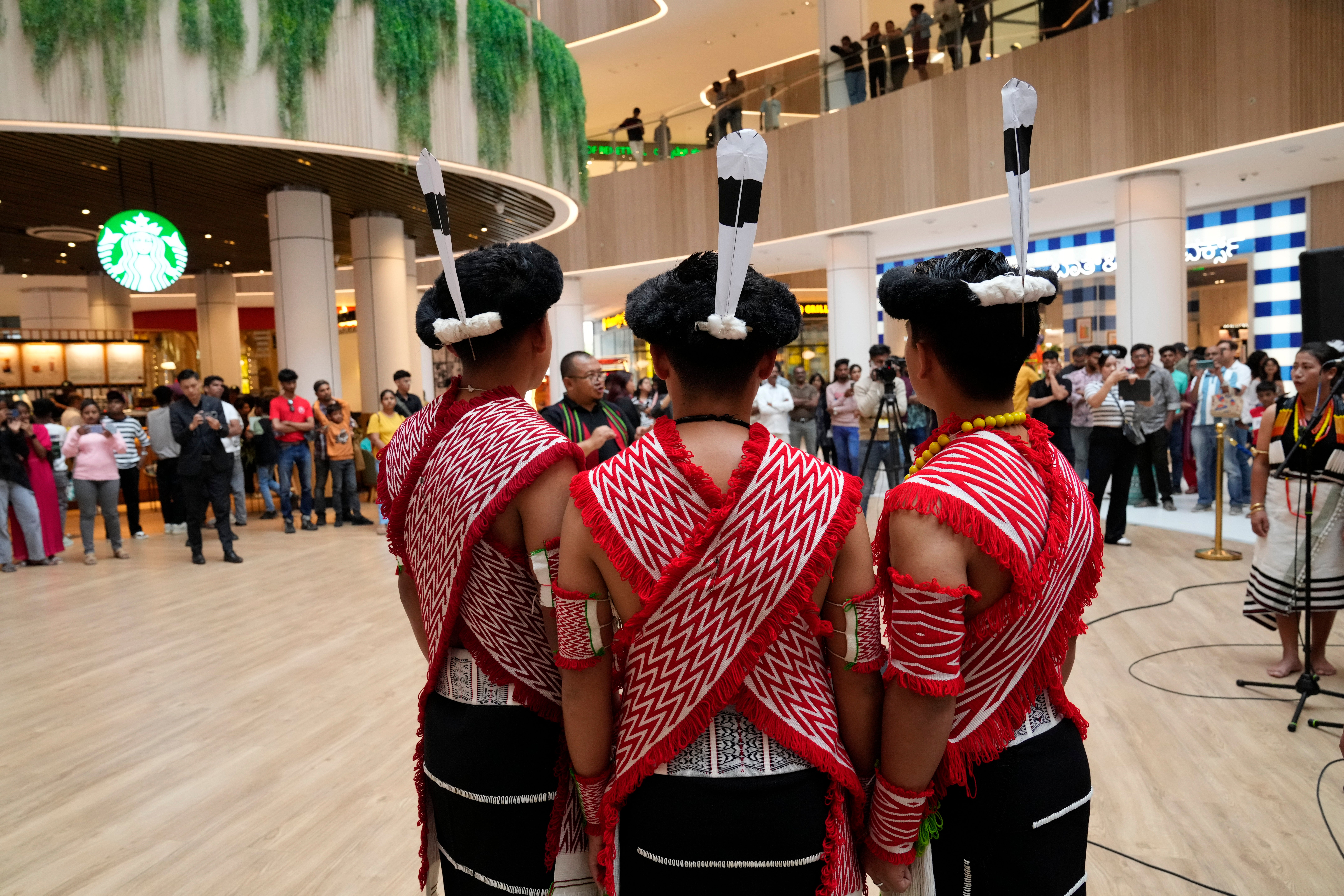 Artists from India’s northeastern state of Nagaland wearing traditional attire perform for a performance