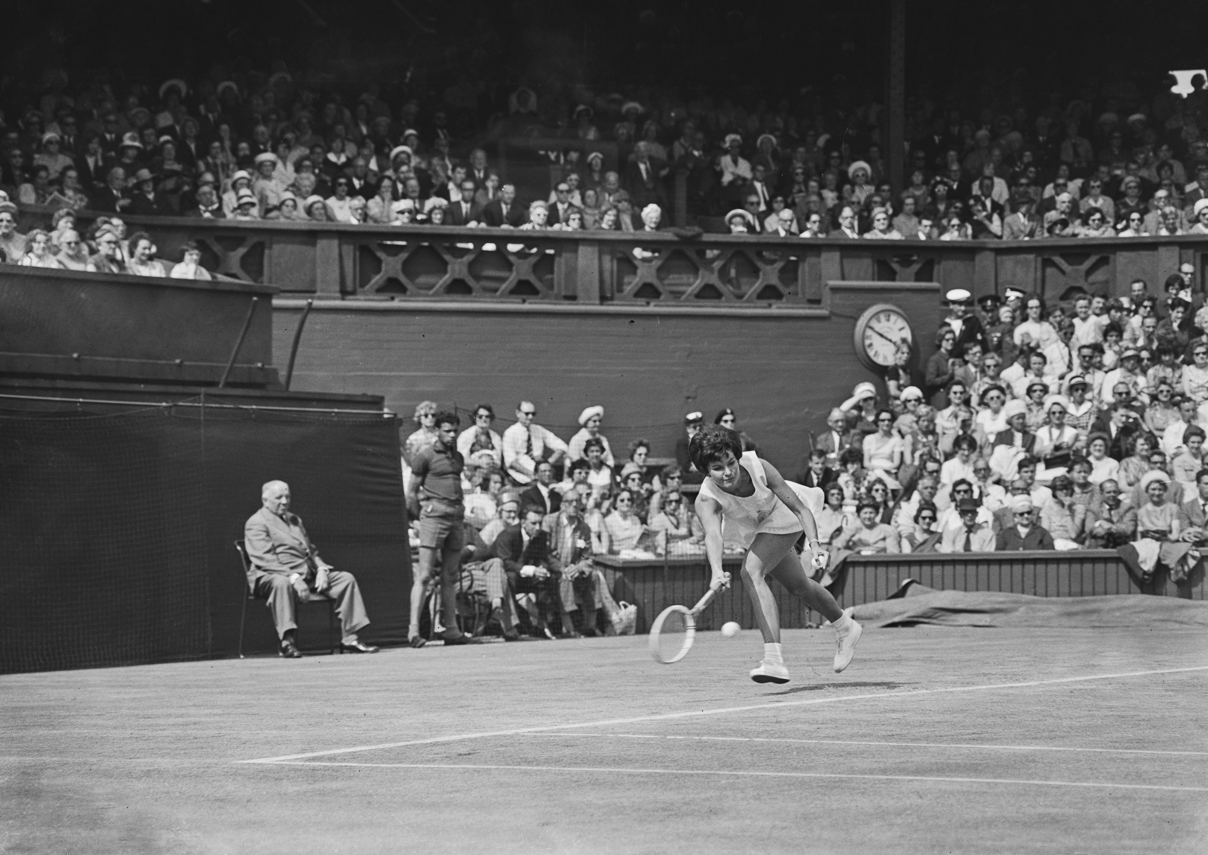 A line judge watches on as German tennis player Helga Schultze plays a shot at the 1963 Championships