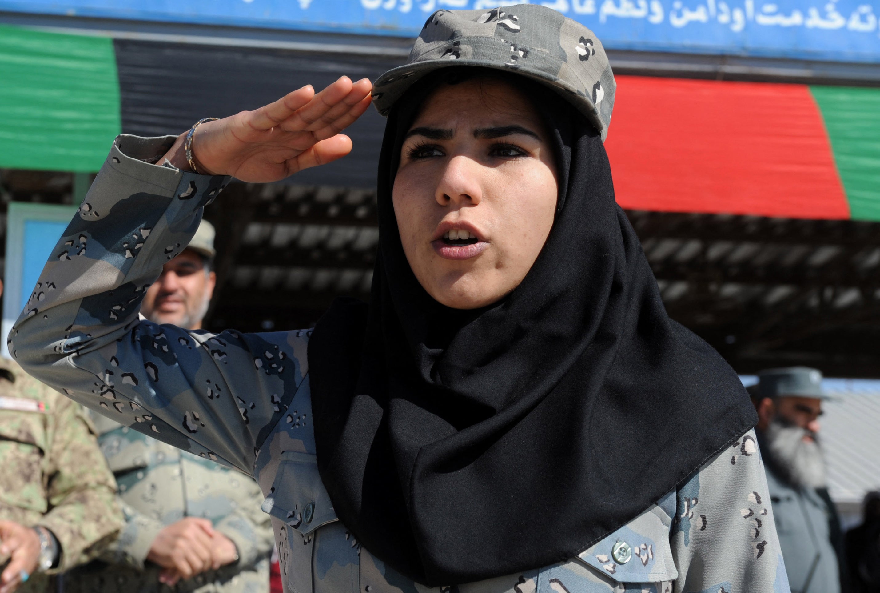 File. An Afghan policewoman salutes during a graduation ceremony in Herat in 2014