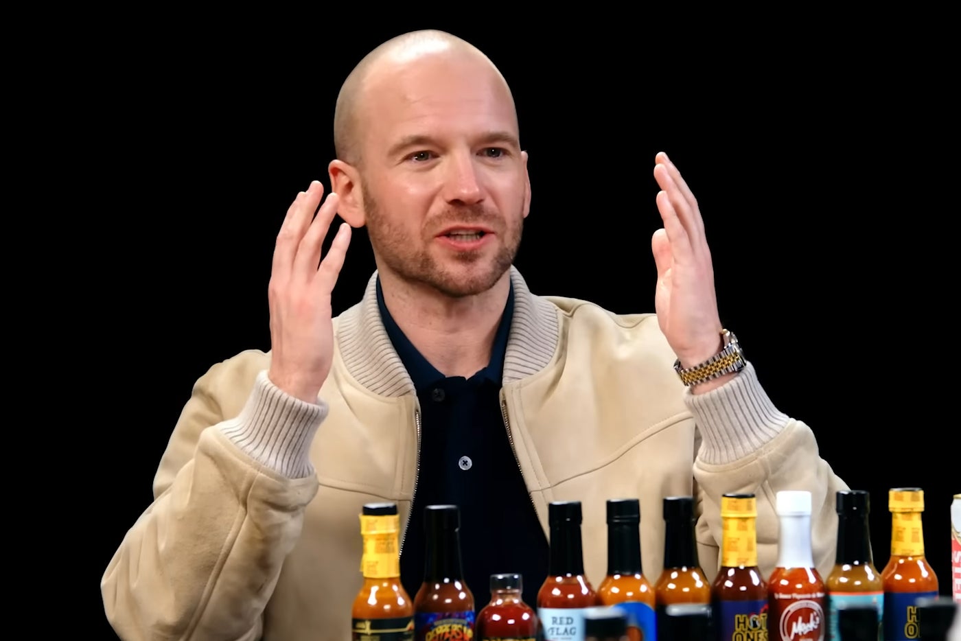 Sean Evans and a line-up of hot sauces on ‘Hot Ones'