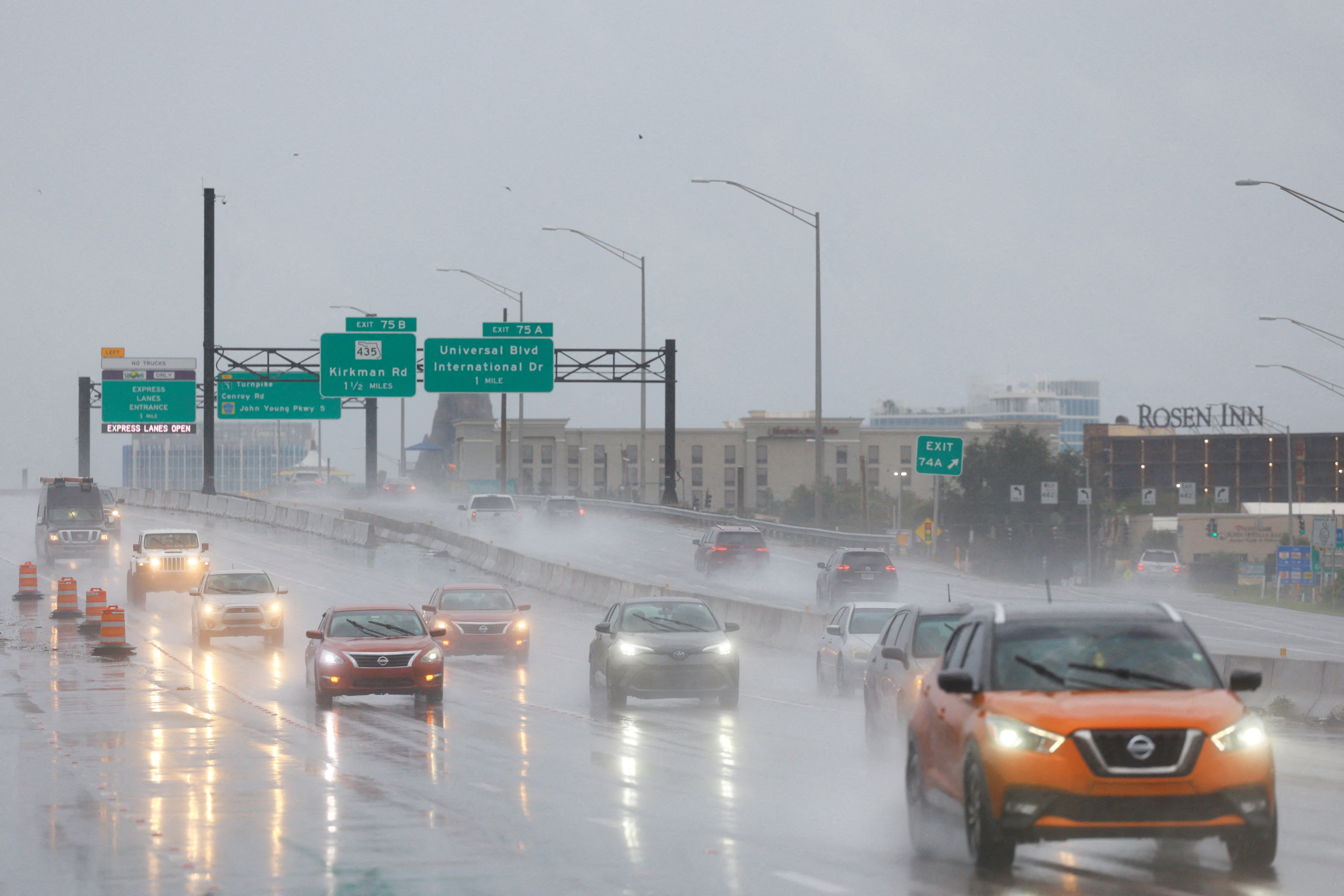 Cars drive in Orlando, Florida amid heavy rainfall ahead of Hurricane Milton. But some residents say they can’t leave because they don’t have enough gas