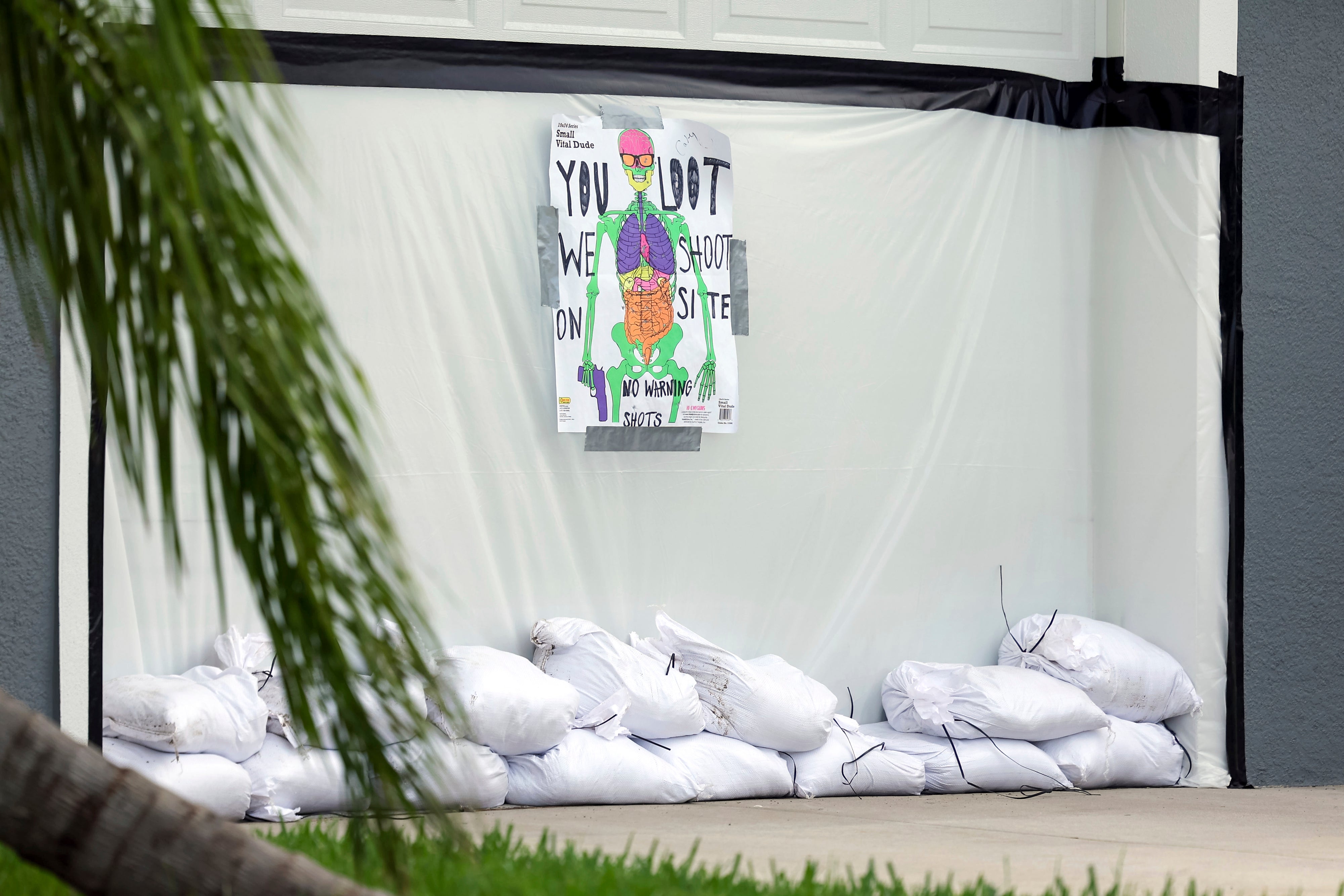 A sign that reads “You loot, we shoot on site” in New Port Richey, Florida ahead of Hurricane Milton as residents try to scare of looters