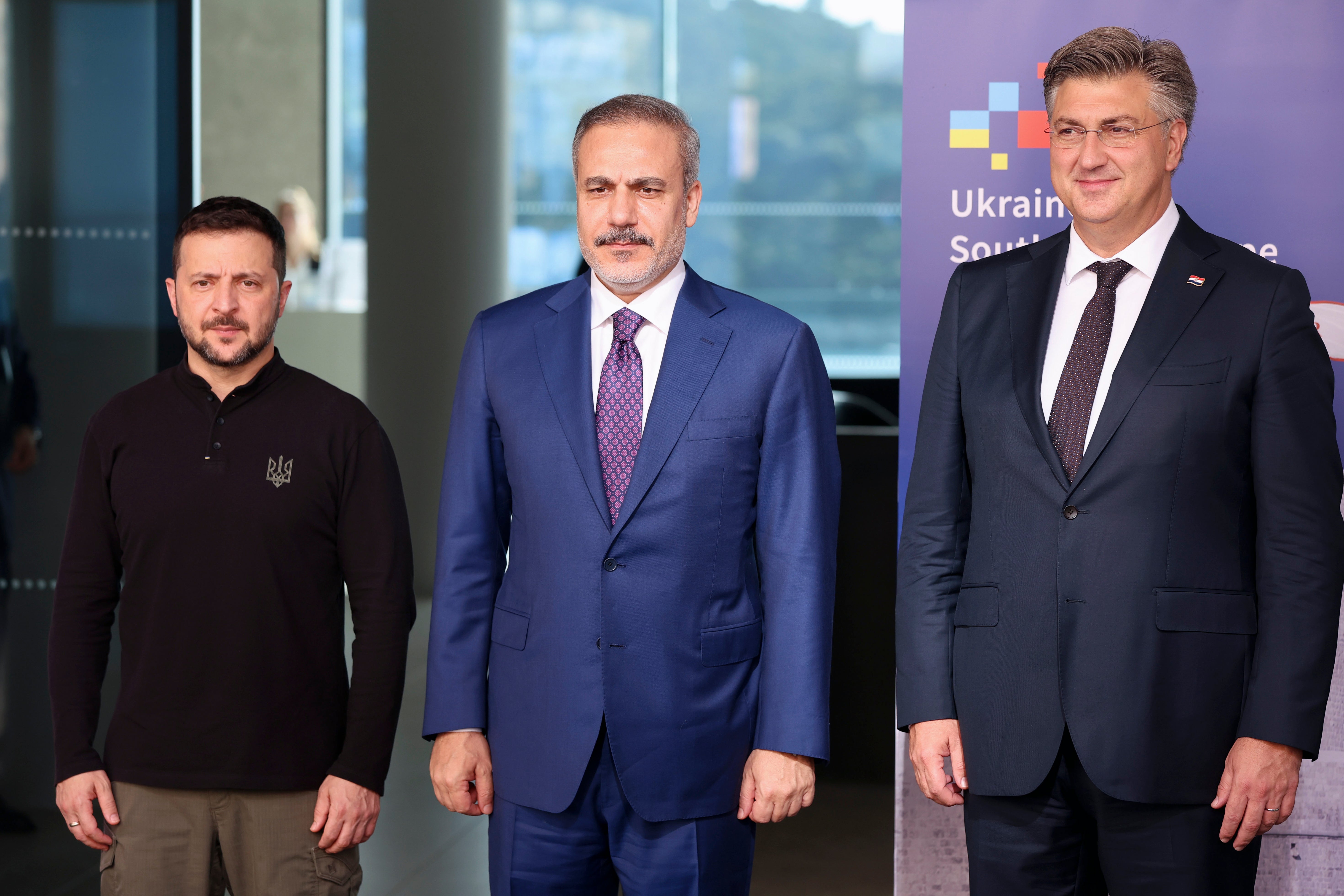 Ukrainian President Volodymyr Zelenskyy, left with Turkish Foreign Minister Hakan Fidan, centre, earlier this year