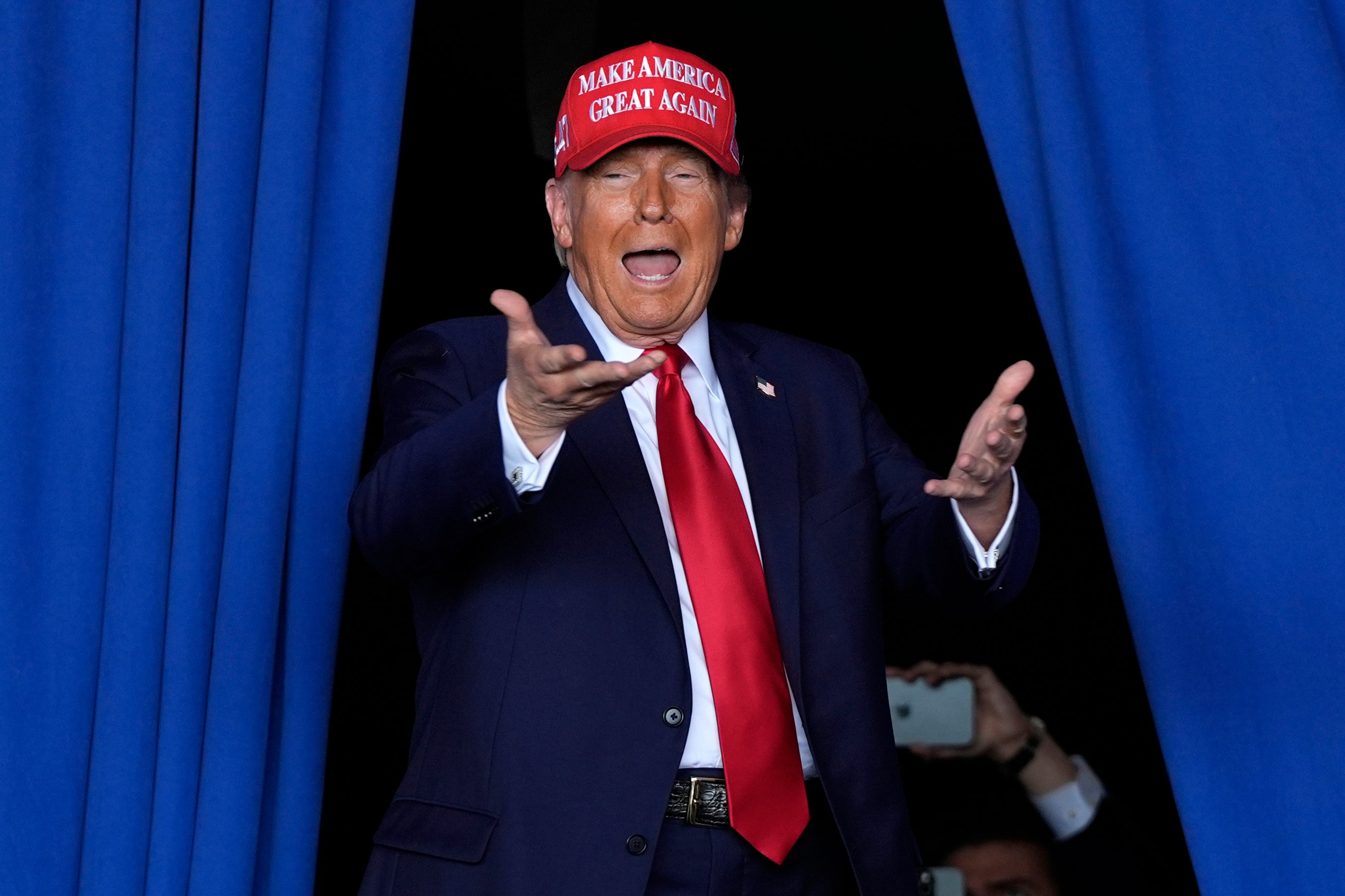 Donald Trump arrives to speak during a campaign rally at Dodge County Airport, Sunday, Oct. 6, 2024, in Juneau, Wisconsin.