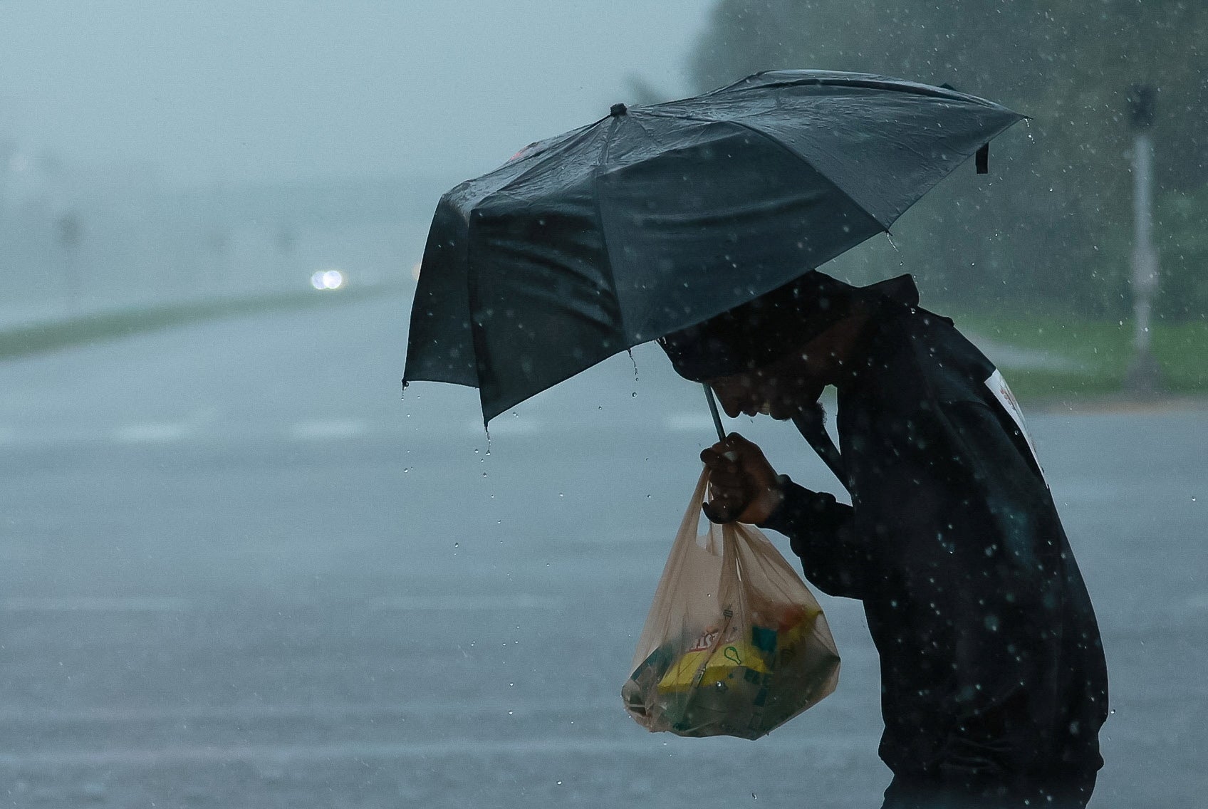 A person holds an umbrella as Hurricane Milton nears Orlando, Florida, on Wednesday.