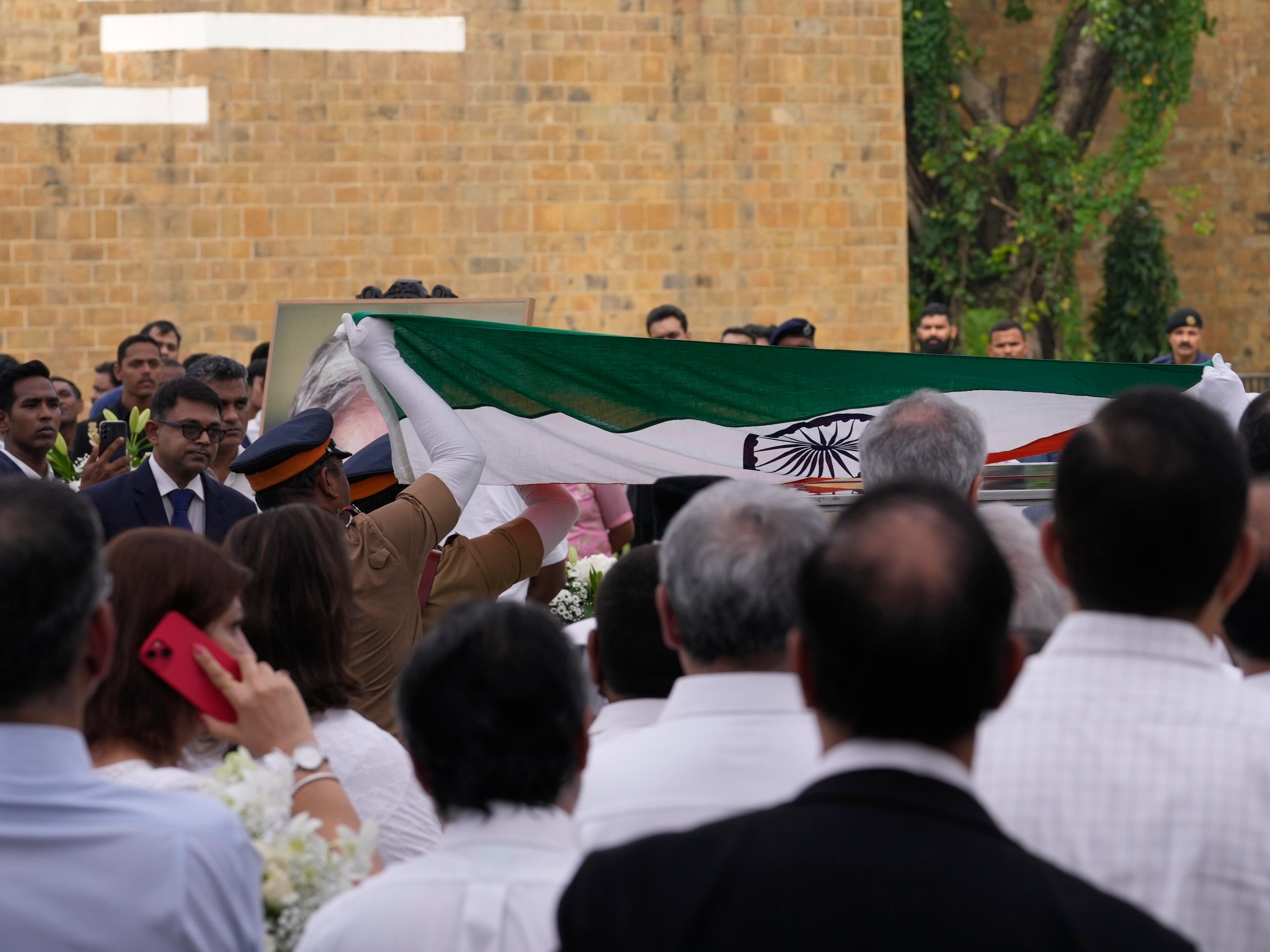An Indian flag is laid on the body of Indian business leader Ratan Tata who died on Wednesday as people pay homage in Mumbai, India, Thursday, 10 October 2024
