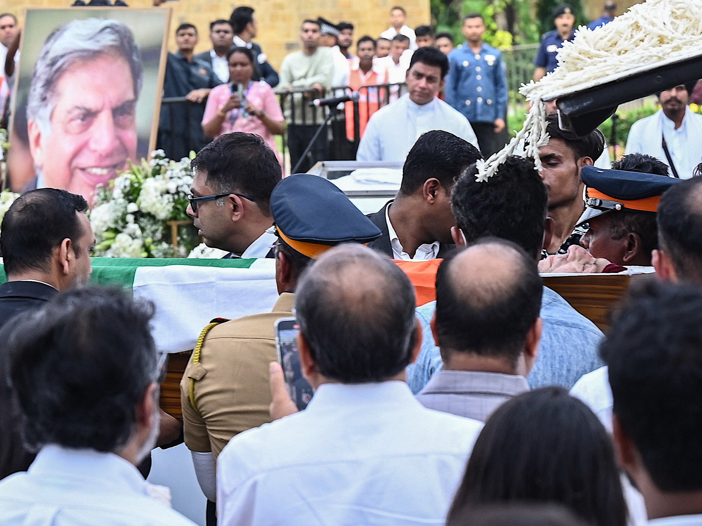 Indian industrialist Ratan Tata’s remains (centre, R) are being carried for a public homage at the National Centre for the Performing Arts (NCPA) ahead of its cremation in Mumbai on 10 October 2024