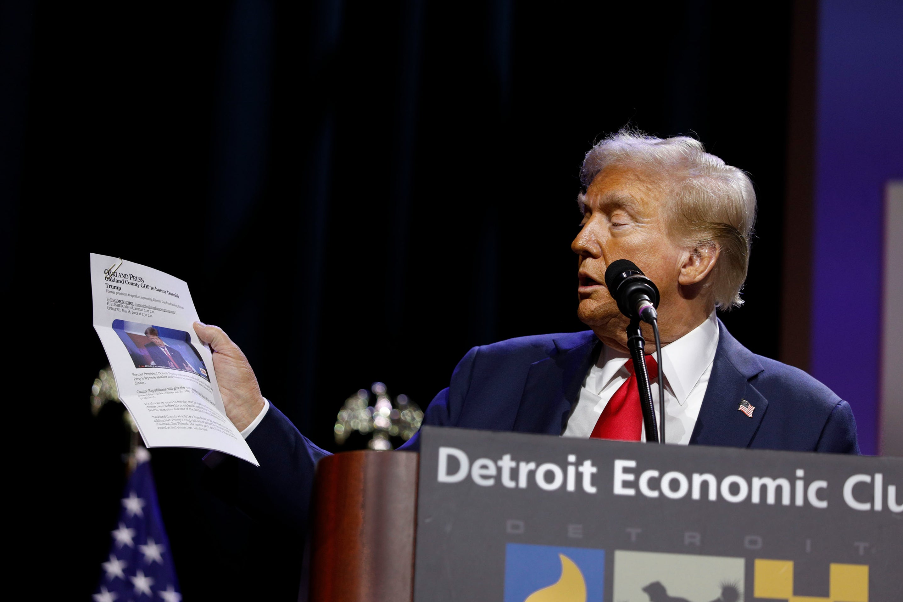 Donald Trump held up a printed version of an article and incorrectly claimed he was named ‘Man of the Year’ at the Detroit Economic Club