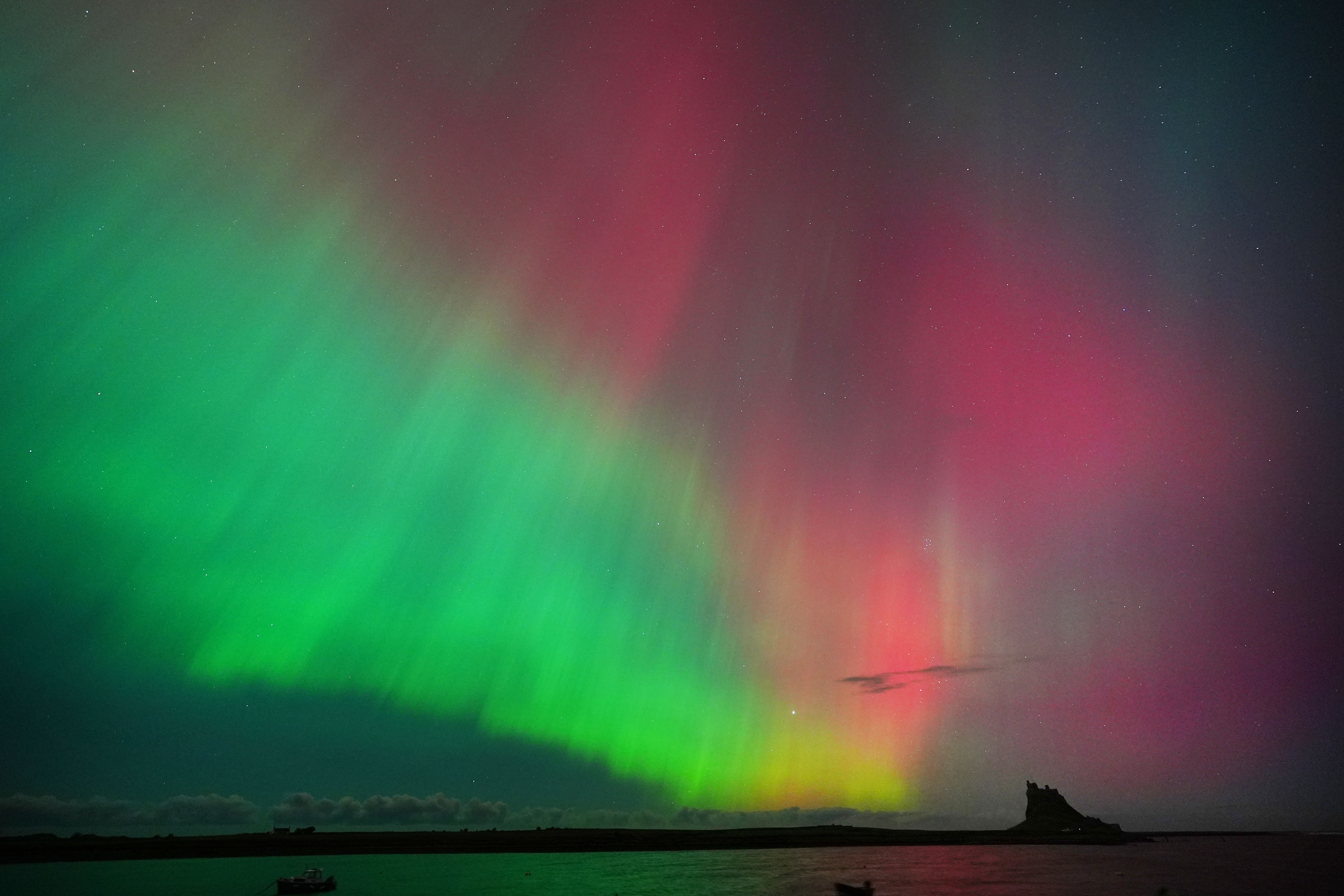 The Northern Lights put on an incredible display in the skies over over Lindisfarne Castle on Holy Island in Northumberland (Owen Humphreys/PA)