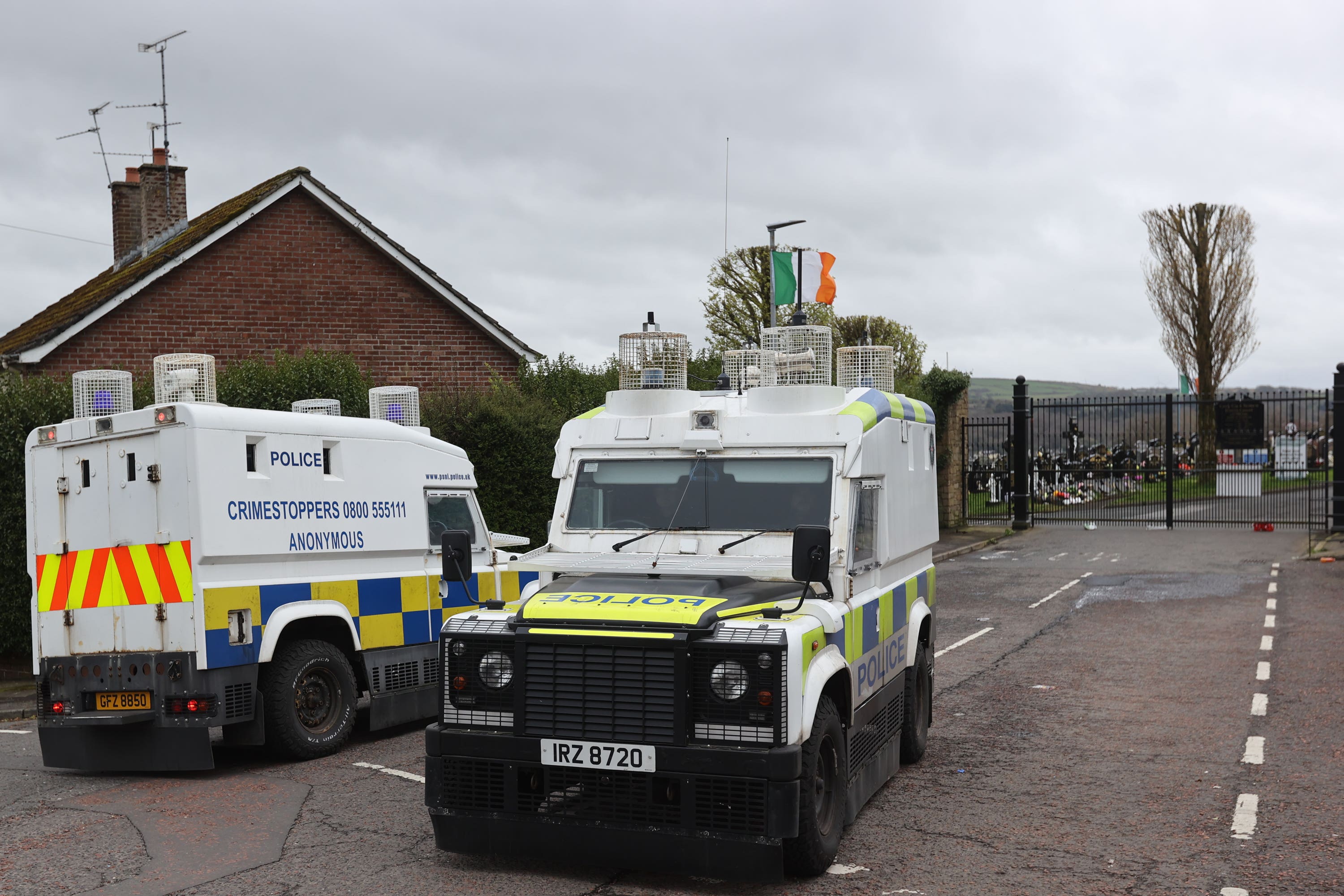 PSNI vehicles outside Derry City Cemetery (Liam McBurney/PA)