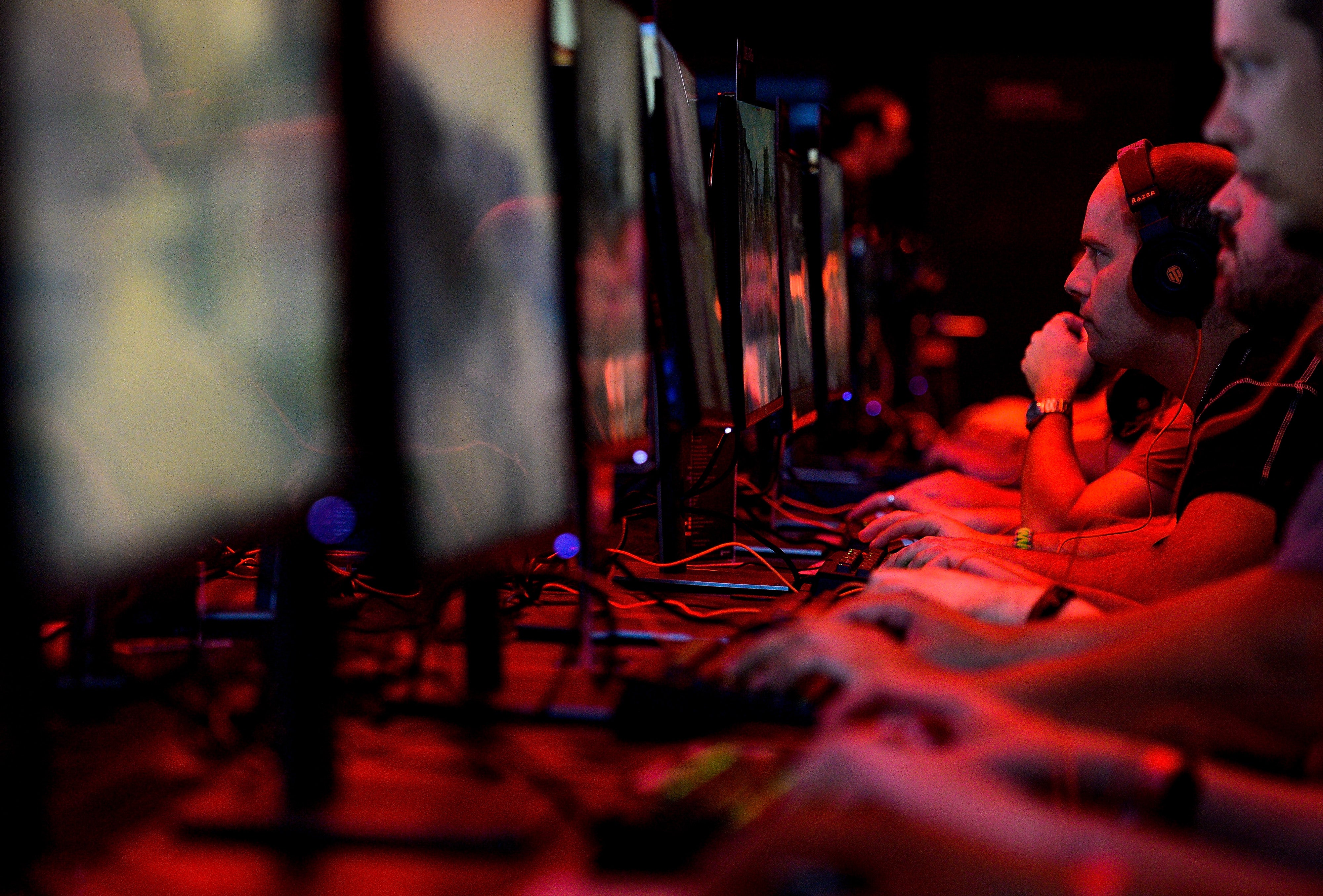 Visitors try out a multiplayer game at the Blizzard Entertainment stand at the Gamescom 2016 gaming trade fair during the media day on August 17, 2016 in Cologne, Germany