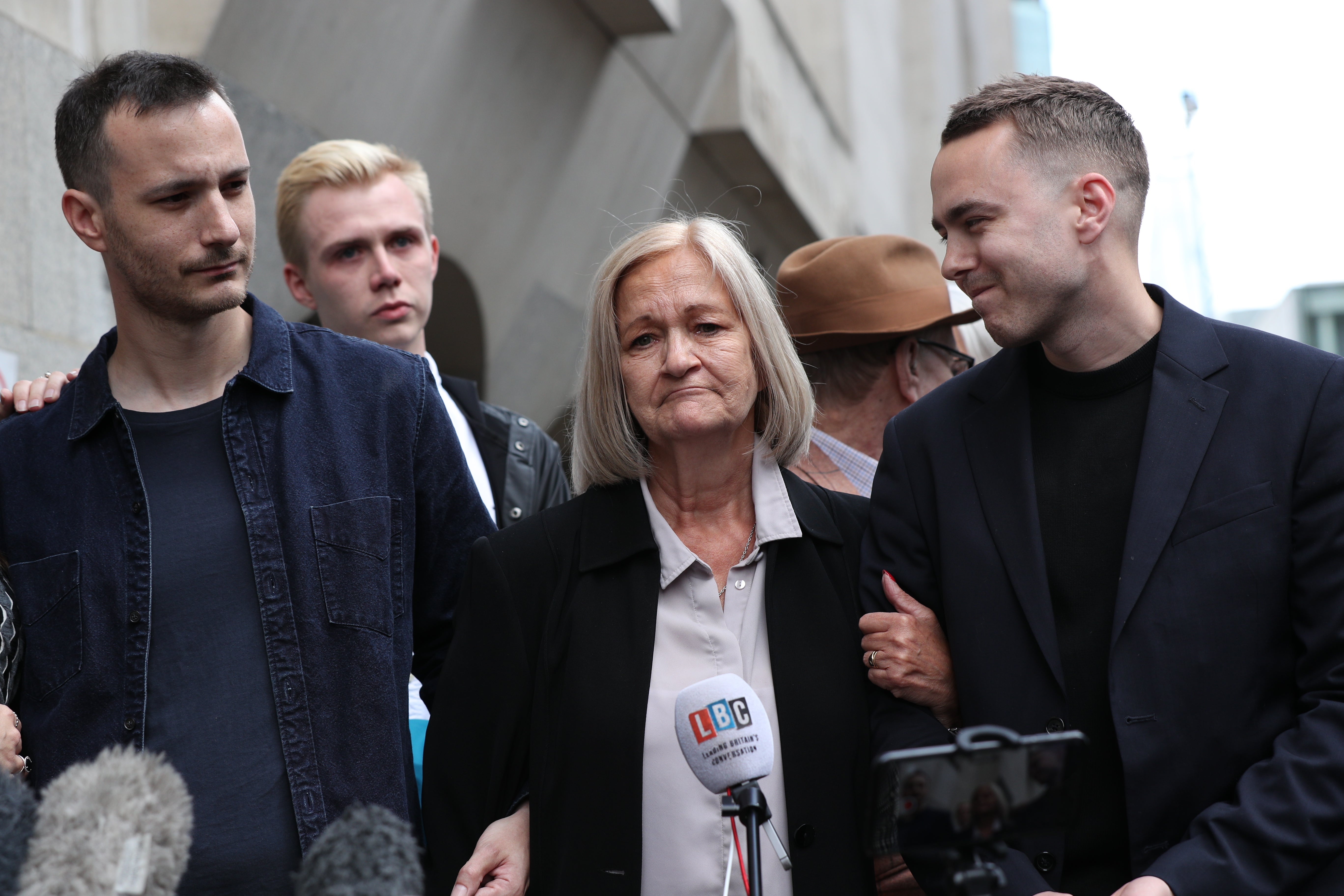 Sally Challen, flanked by her sons James (left) and David (right), leaves the Old Bailey after hearing she will not face a retrial over the death of her husband Richard Challen, who died in 2010